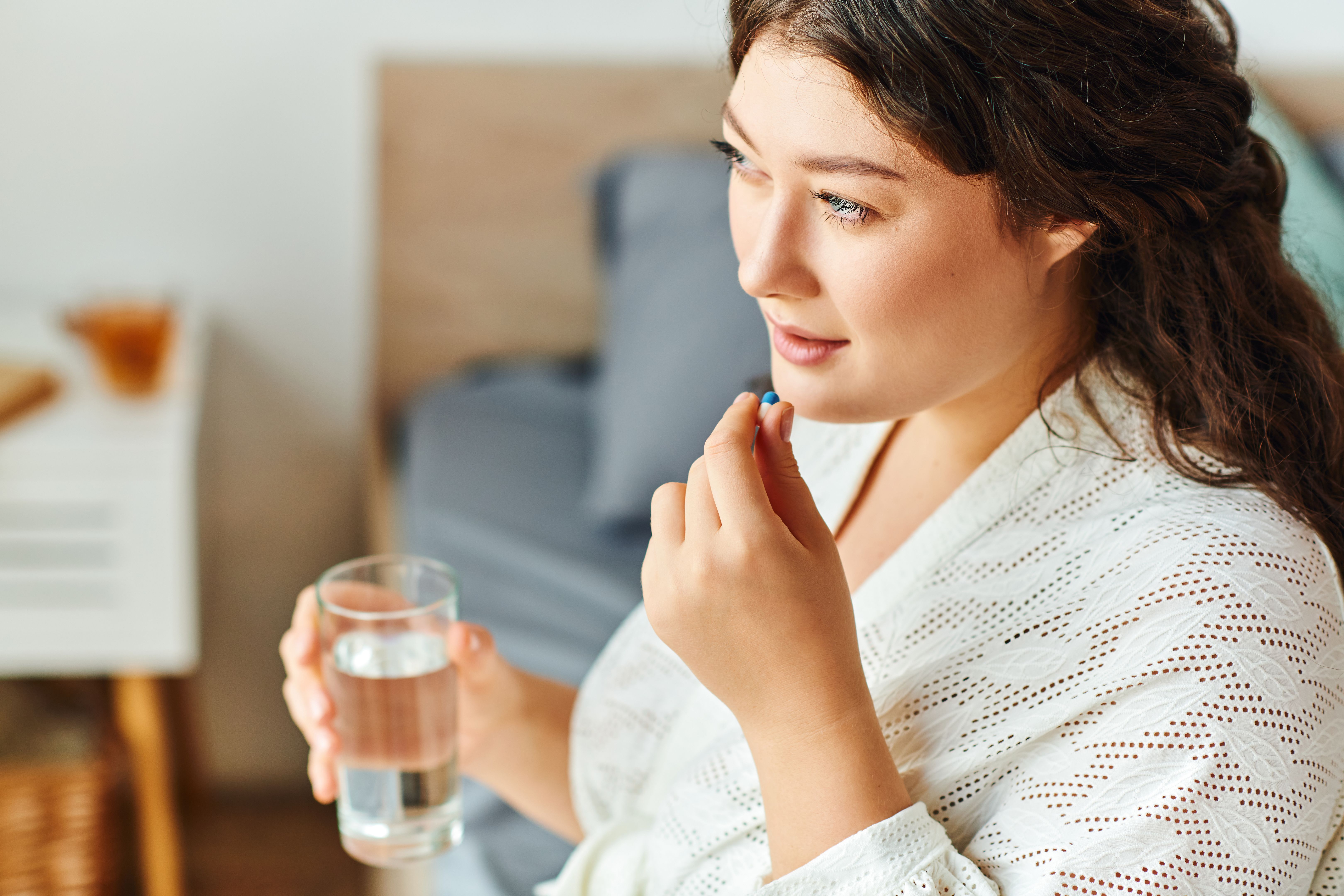 A beautiful plus size woman takes a wellness moment while enjoying her morning routine at home A beautiful plus size woman takes a wellness moment while enjoying her morning routine at home