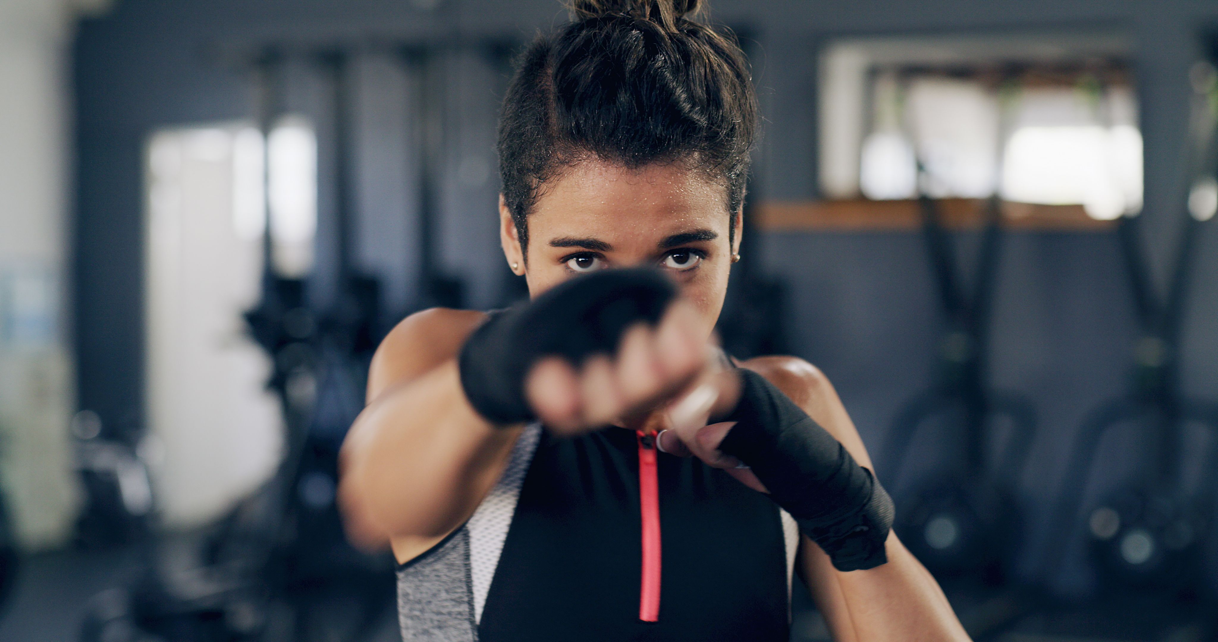 Woman, portrait and punch for martial arts at gym, training and confidence with power for fight. Person, athlete and fist with combat sports, exercise and workout at fitness club in Costa Rica Woman, portrait and punch for martial arts at gym, training and confidence with power for fight. Person, athlete and fist with combat sports, exercise and workout at fitness club in Costa Rica