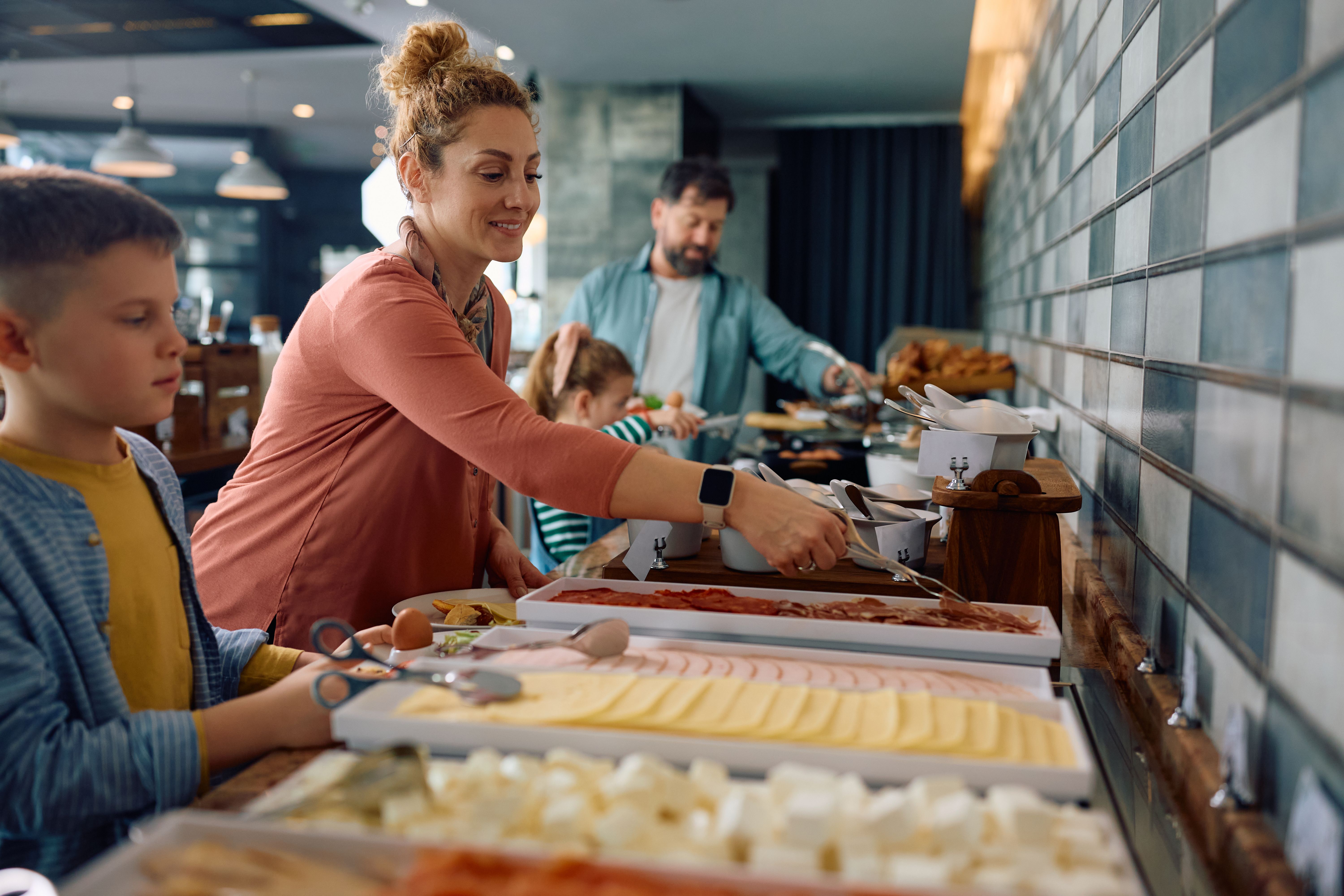 Happy mother enjoying in breakfast at hotel restaurant, Happy mother enjoying in breakfast at hotel restaurant,