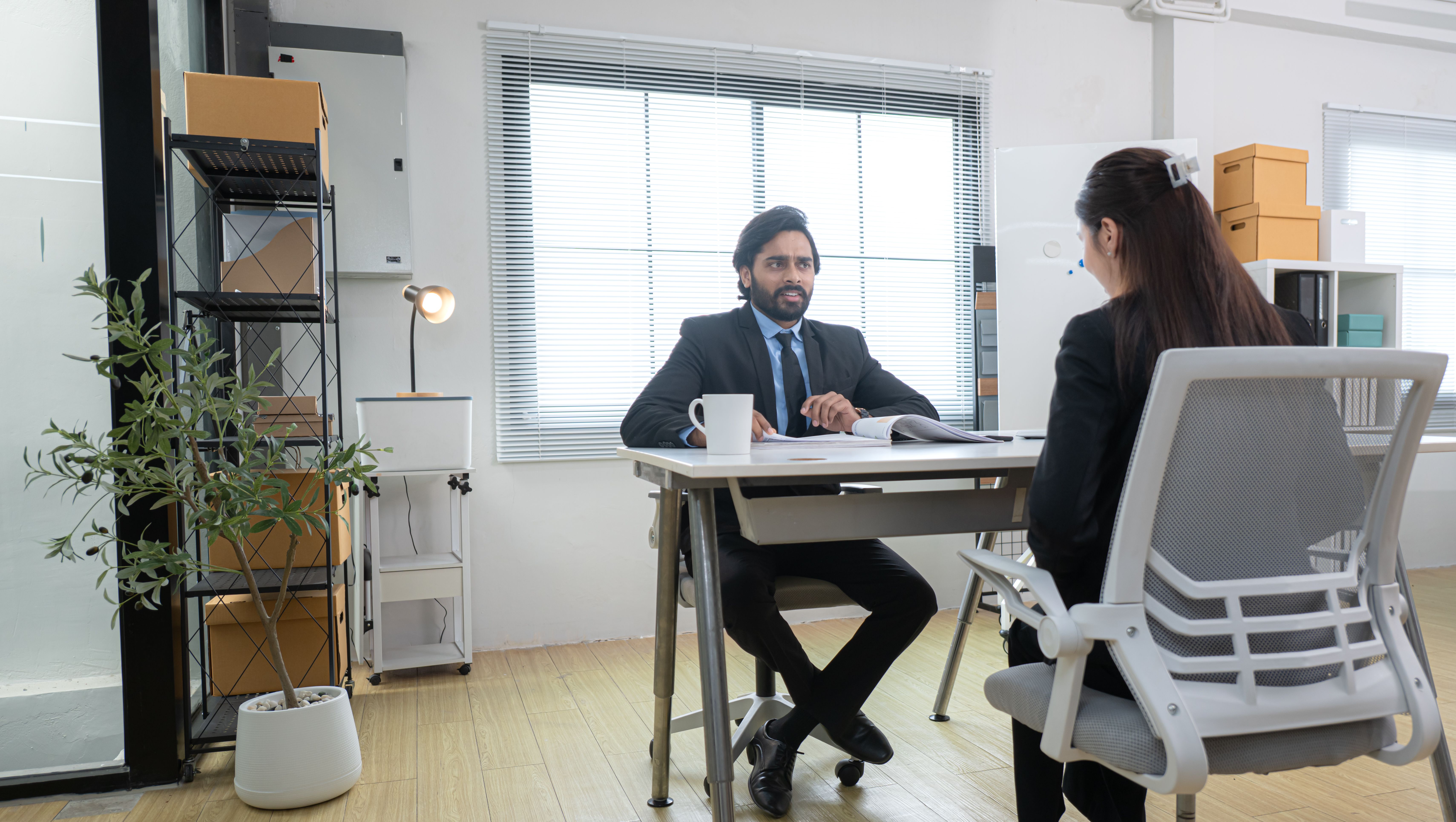 In a contemporary office, two young entrepreneurs are on a mission to generate ideas and establish a business project