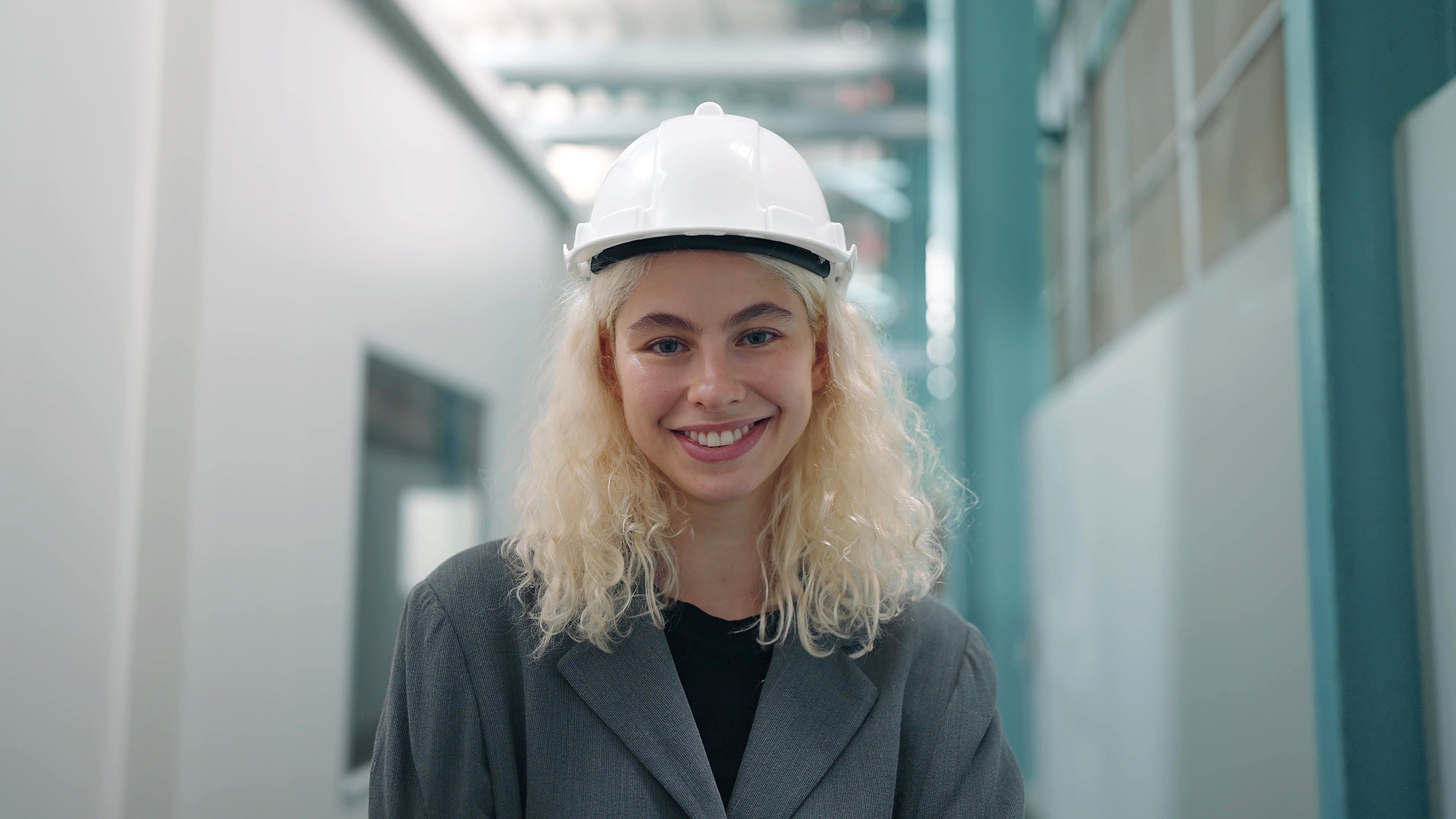 Smiling portrait of beautiful industrial engineer woman in white hard hat stand with confident and looking at camera Smiling portrait of beautiful industrial engineer woman in white hard hat stand with confident and looking at camera