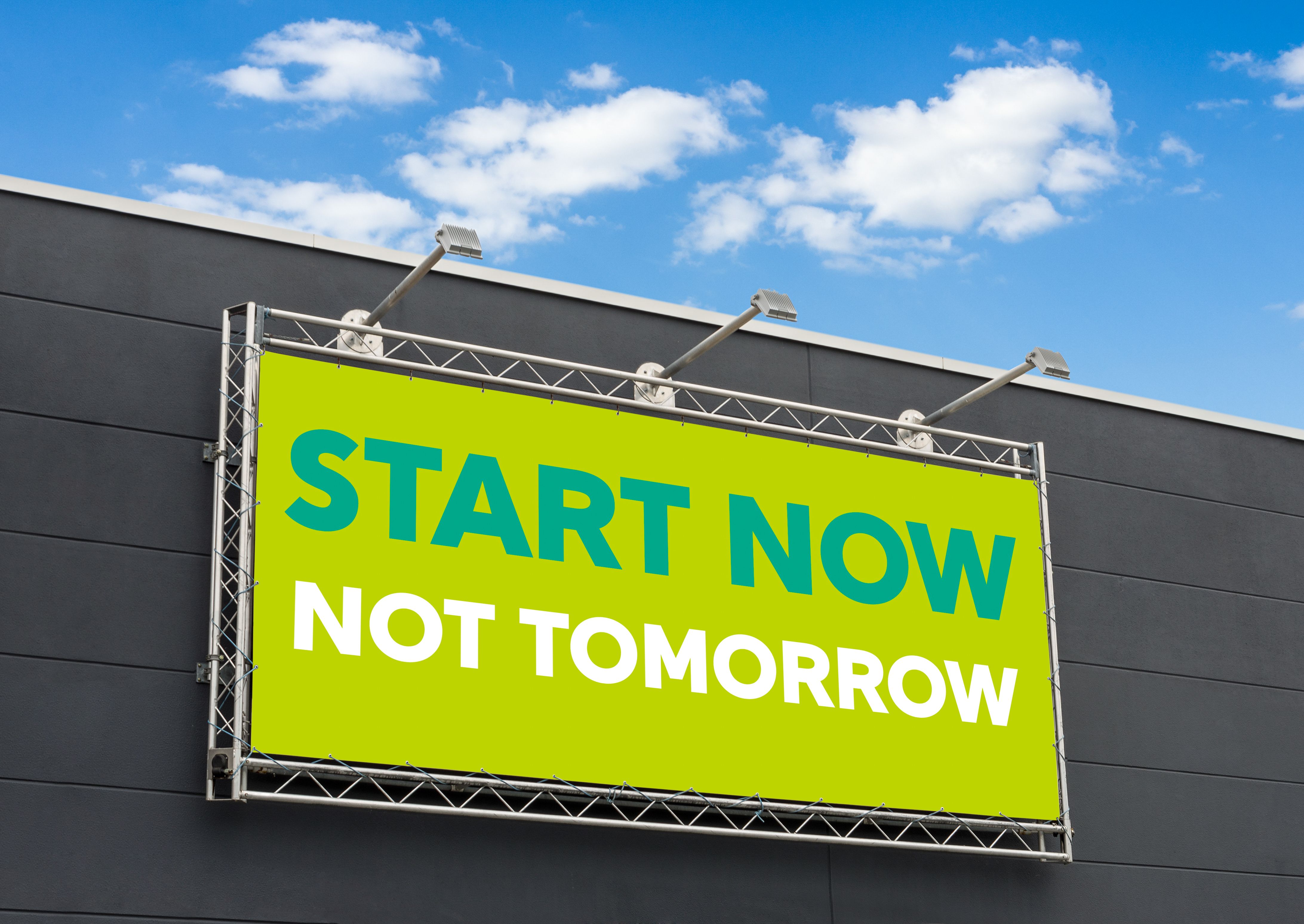 Start now not tomorrow written on a billboard