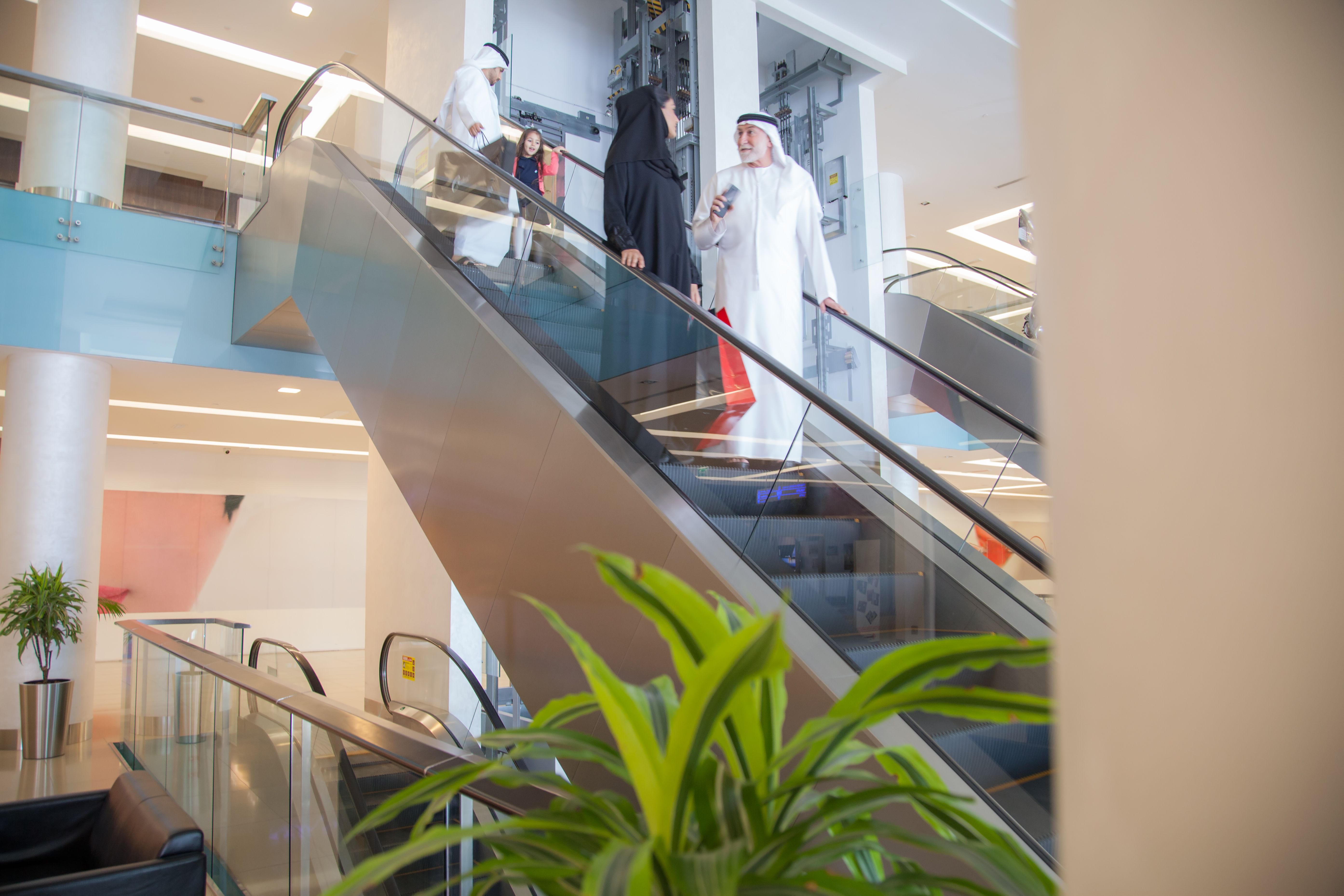 Arabian family on a shopping mall's escalator.