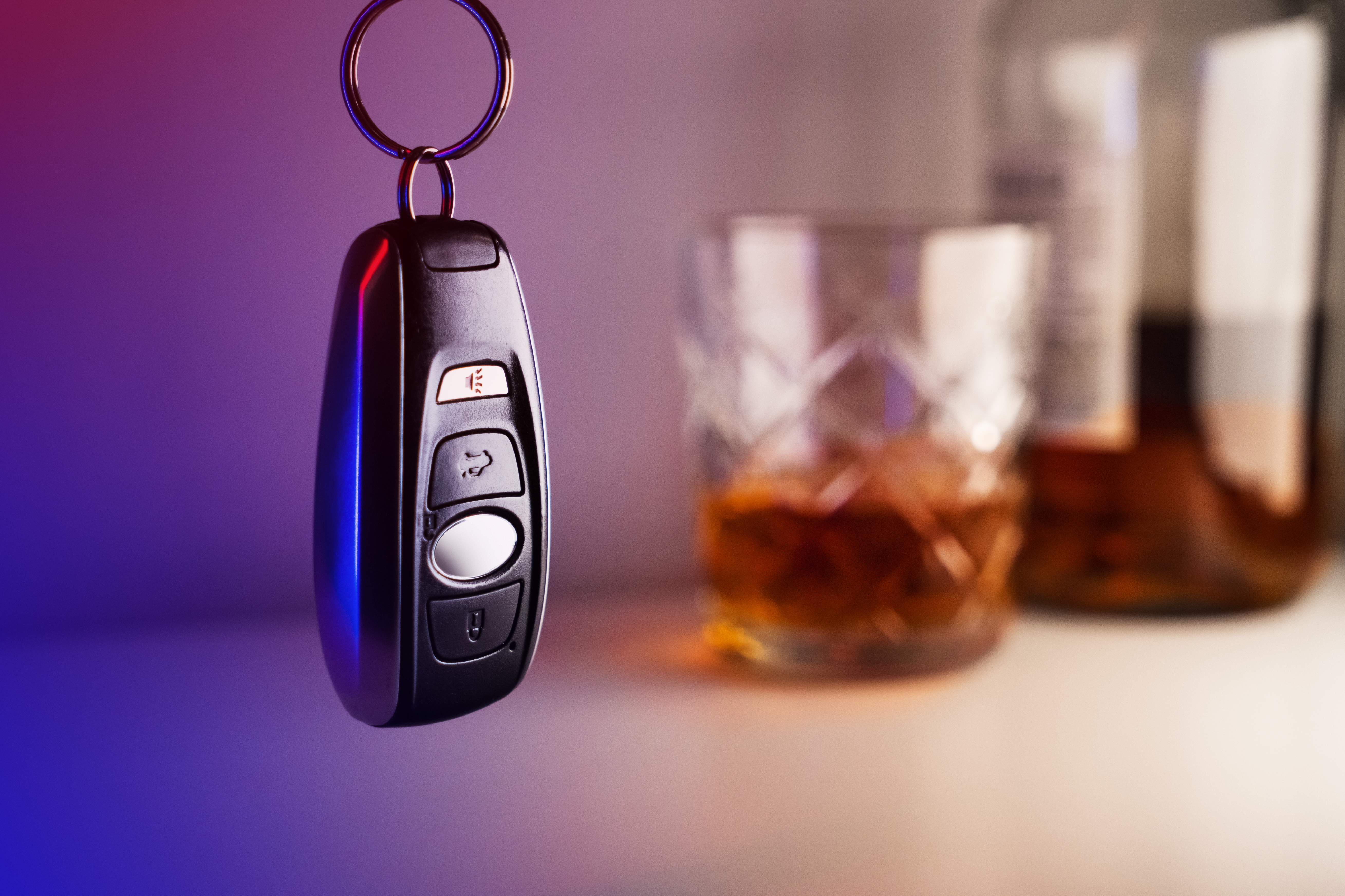 Car keys with glass and bottle of liquor, don't drink and drive concept Car keys with glass and bottle of liquor, don't drink and drive concept