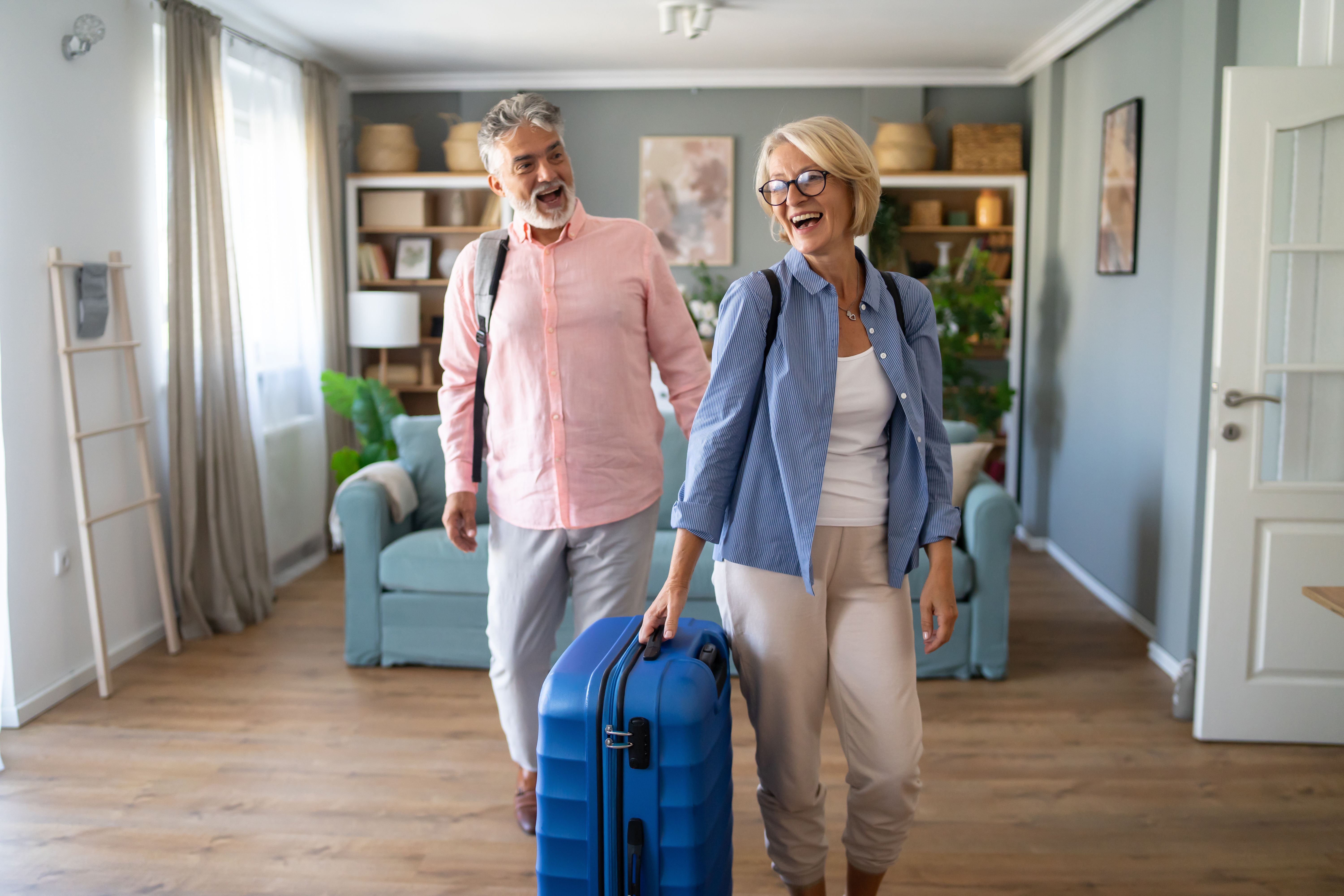 Senior Couple Standing With Suitcase About To Leave For Vacation Senior Couple Standing With Suitcase About To Leave For Vacation