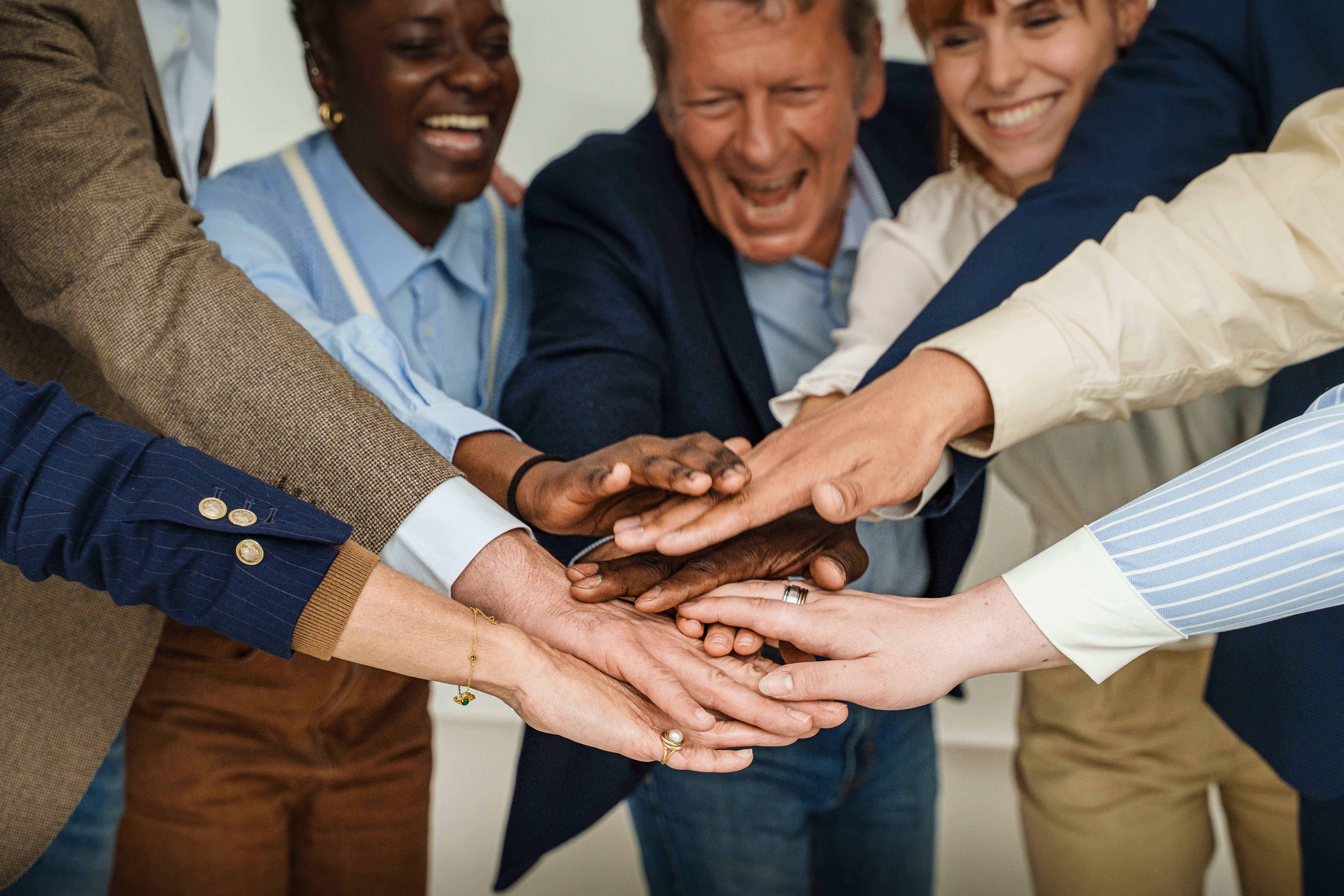 Multicultural Team Celebrating Unity with Hands Joined in Success Multicultural Team Celebrating Unity with Hands Joined in Success