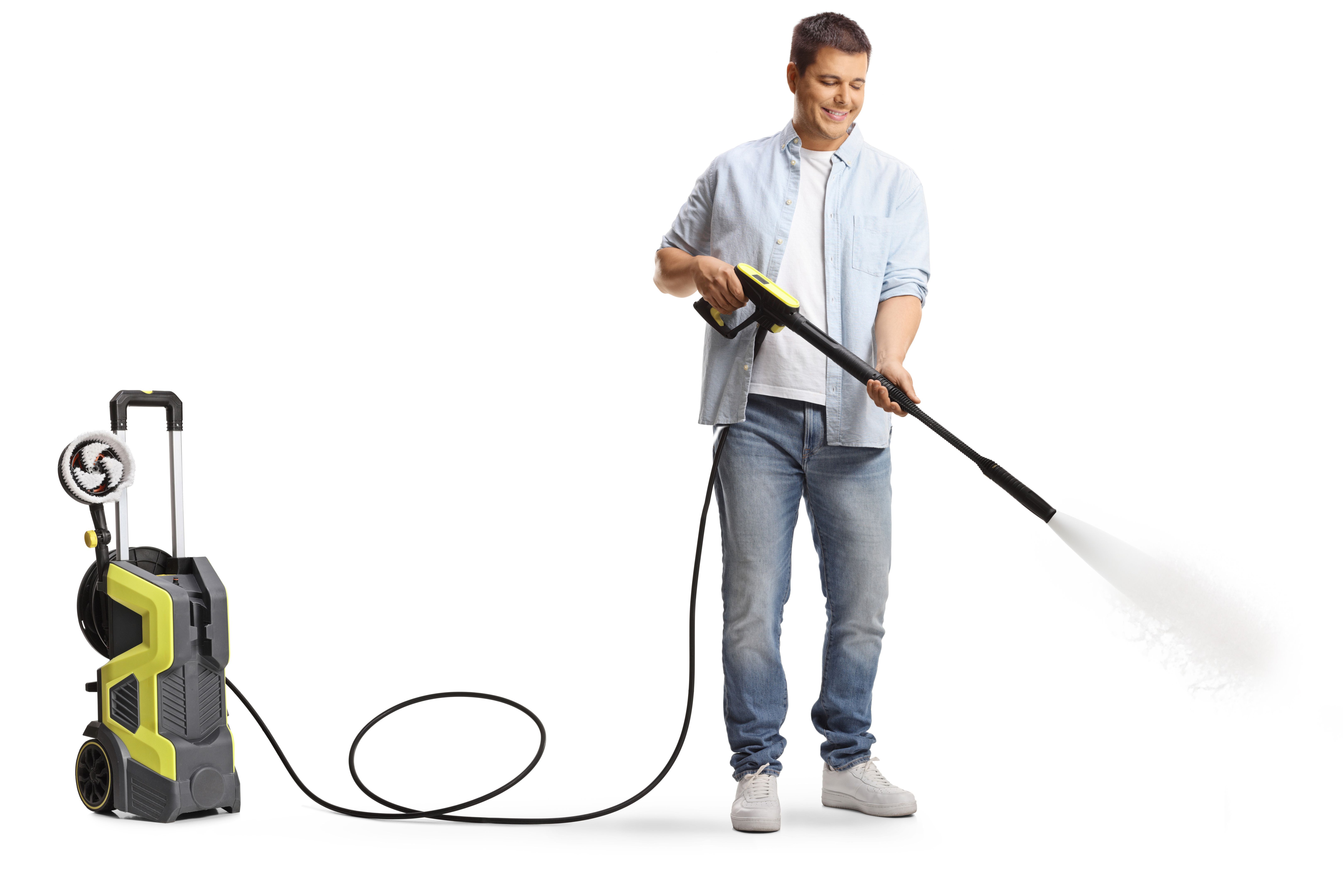 Man cleaning with a high pressure washer machine