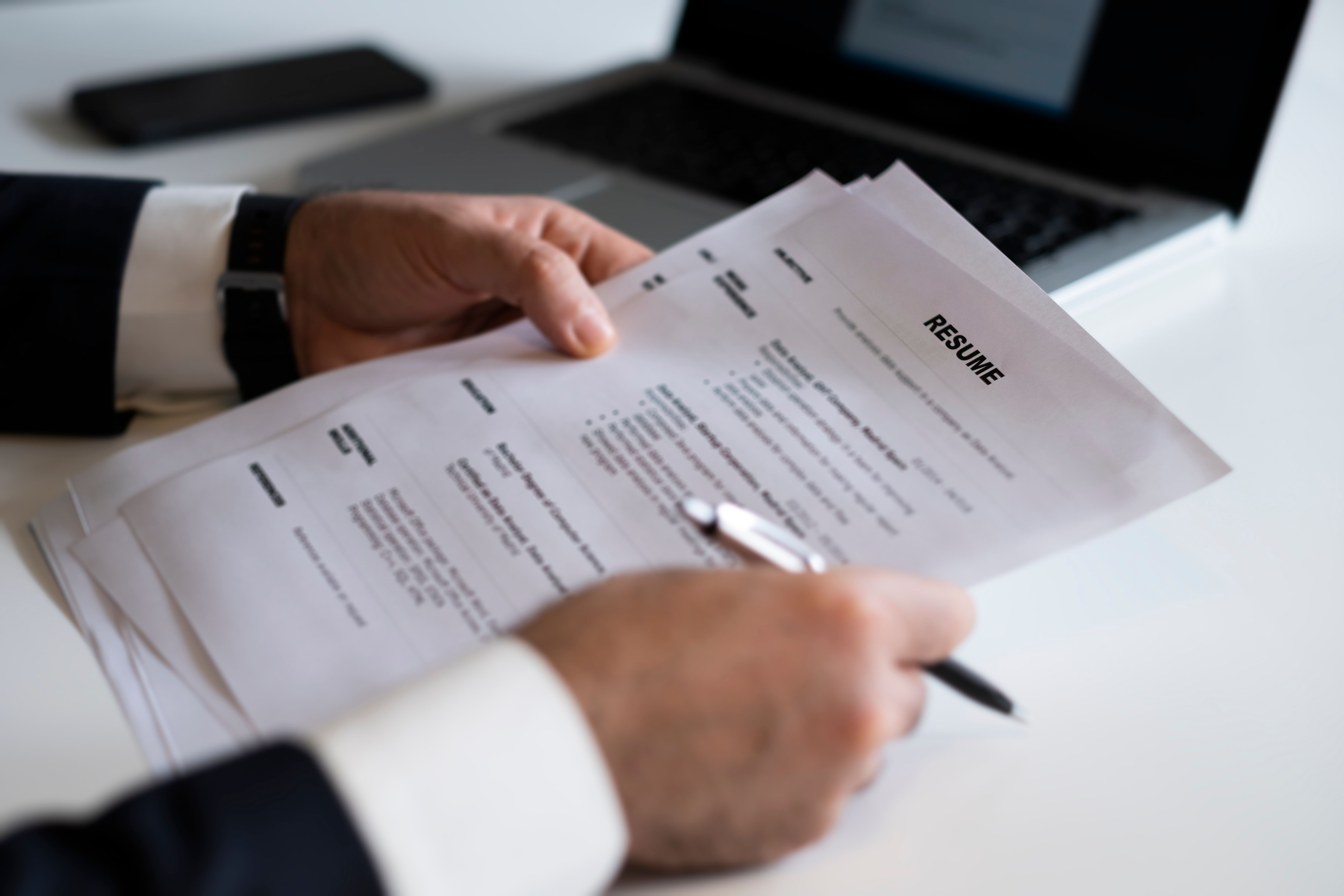 Business man review his resume application on desk