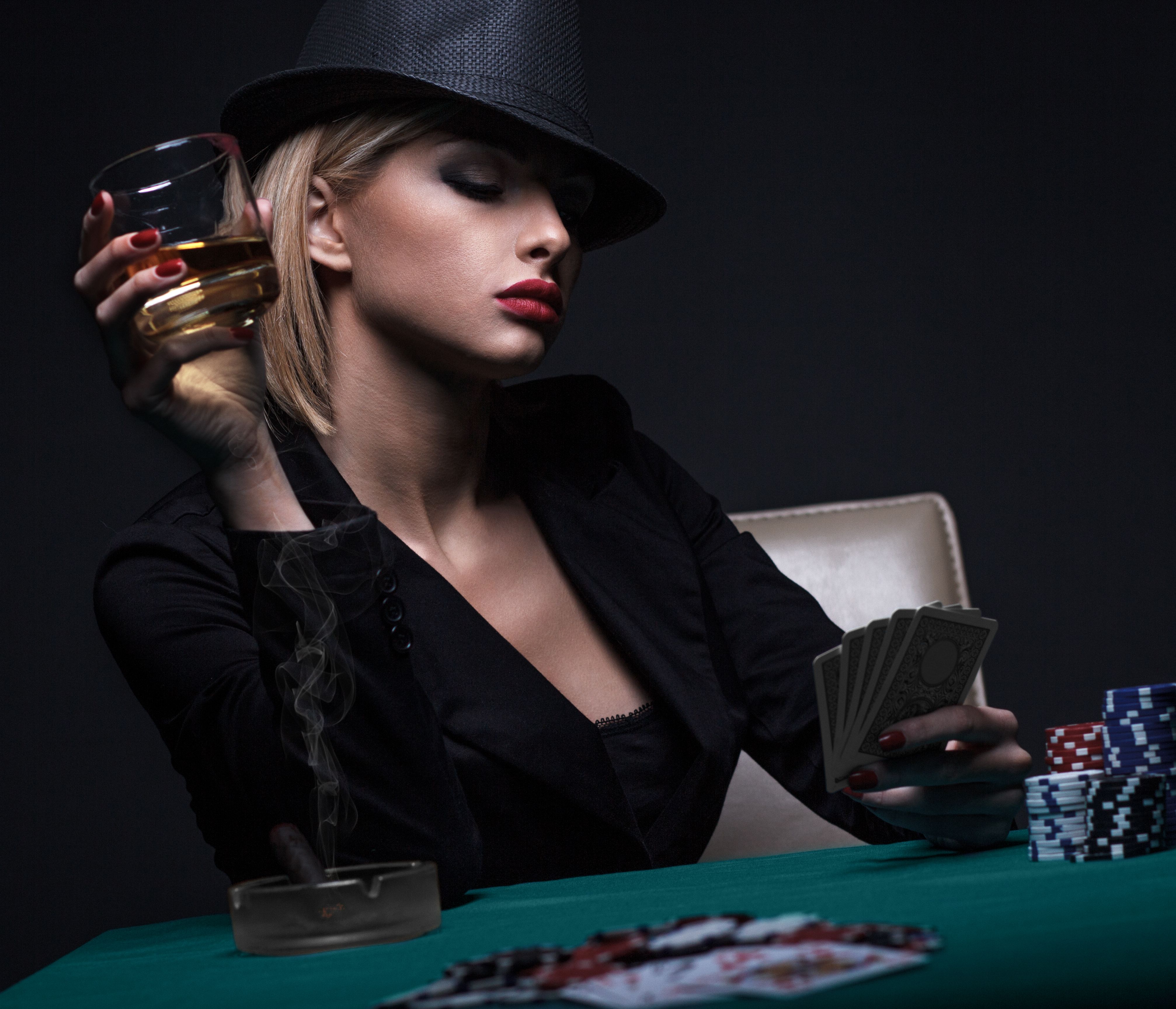 Beautiful young woman playing poker