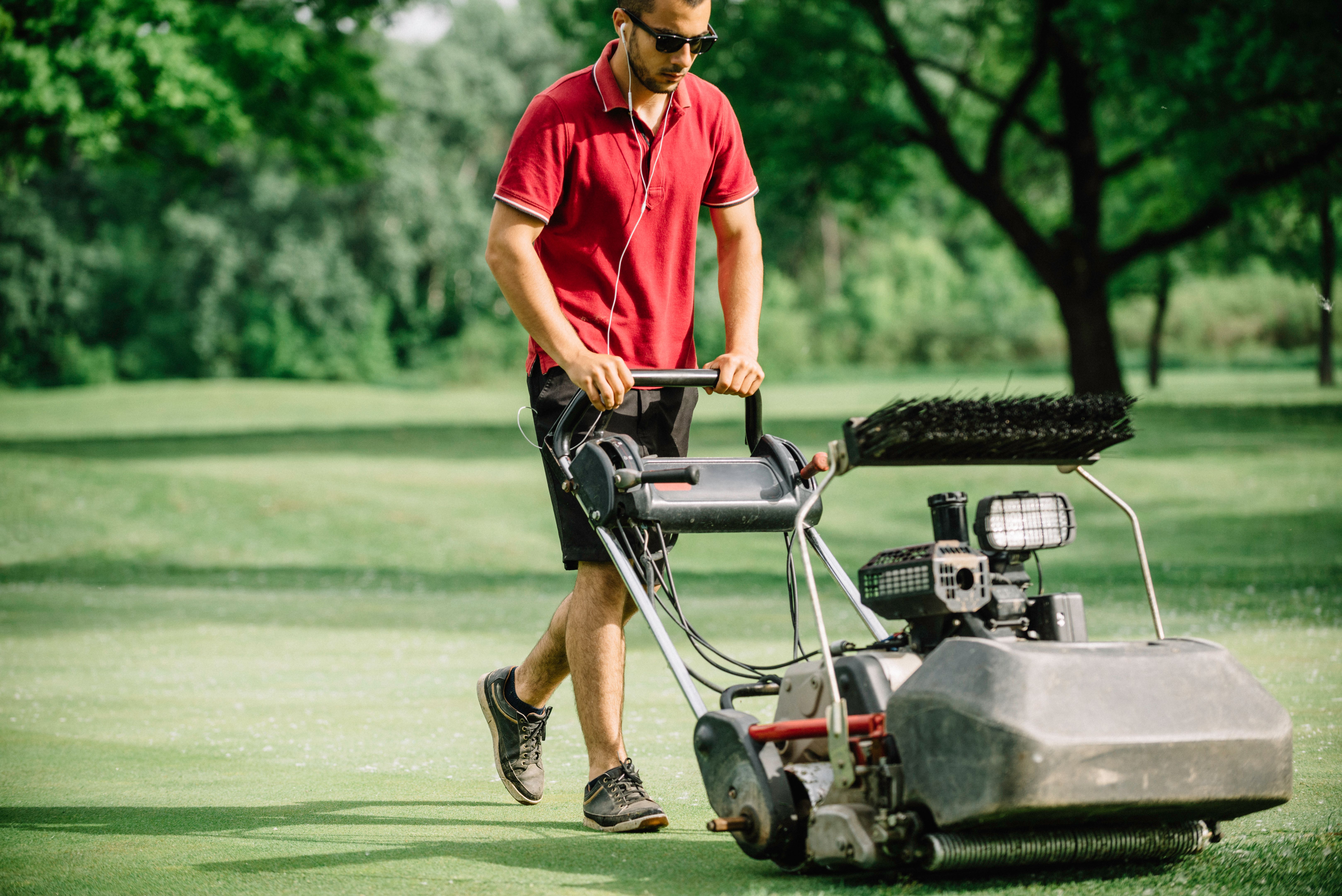 Greenskeeper moving green at a golf course