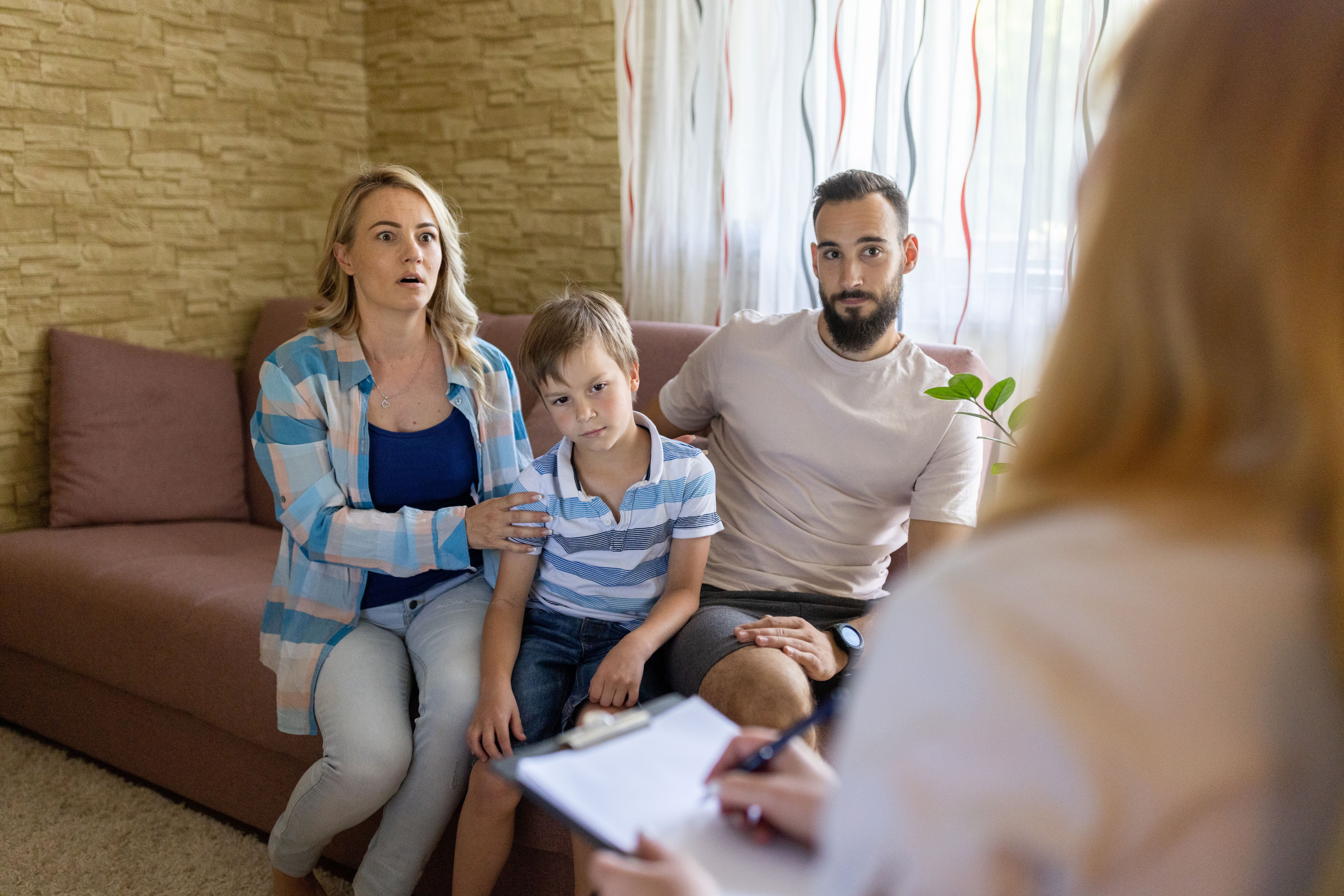 Couple and their son talking whit psychiatrist Couple and their son talking whit psychiatrist