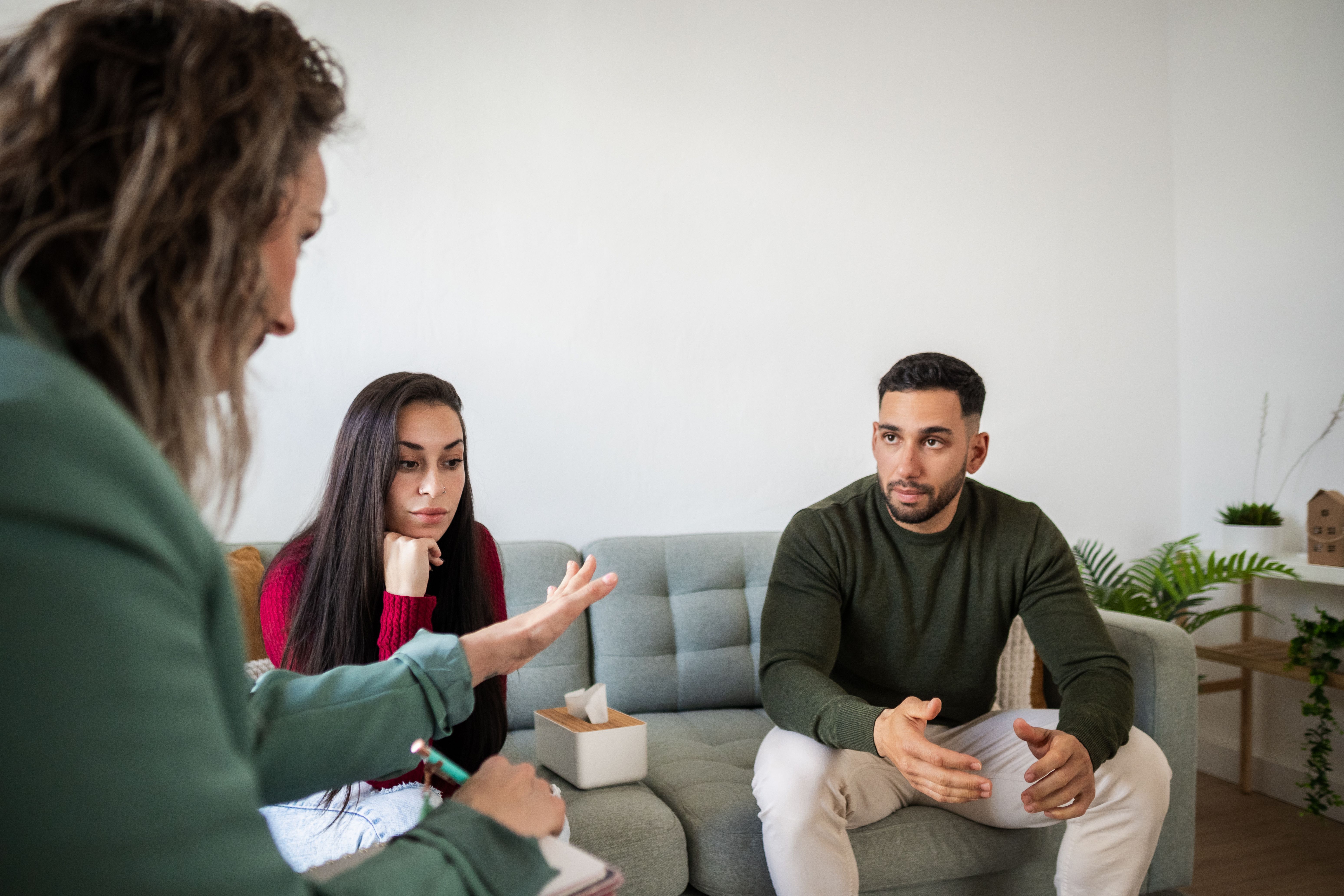 Couple discussing problems with counselor during therapy session