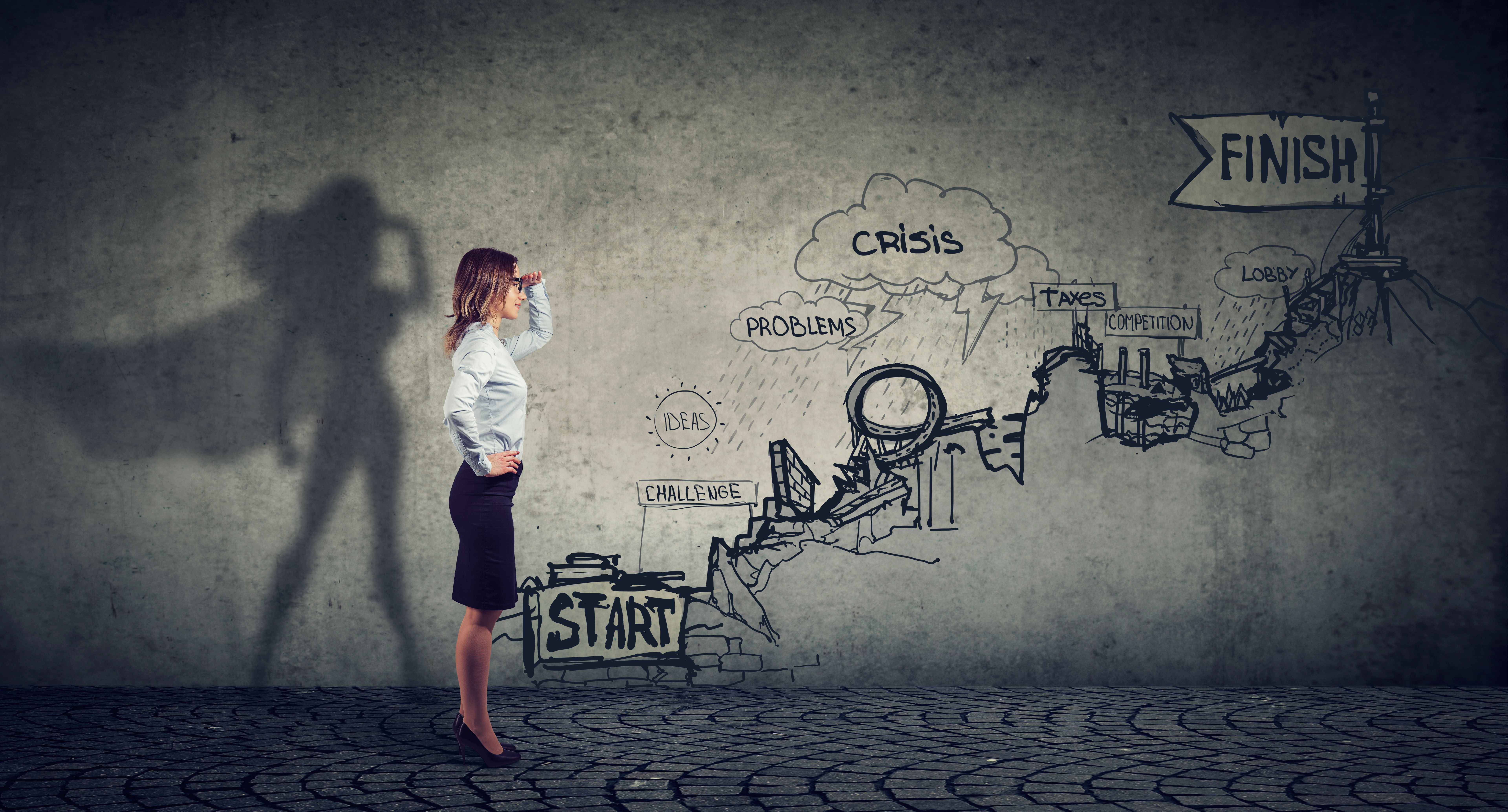 Businesswoman imagining to be a super hero looking aspired making career plans Businesswoman imagining to be a super hero looking aspired making career plans