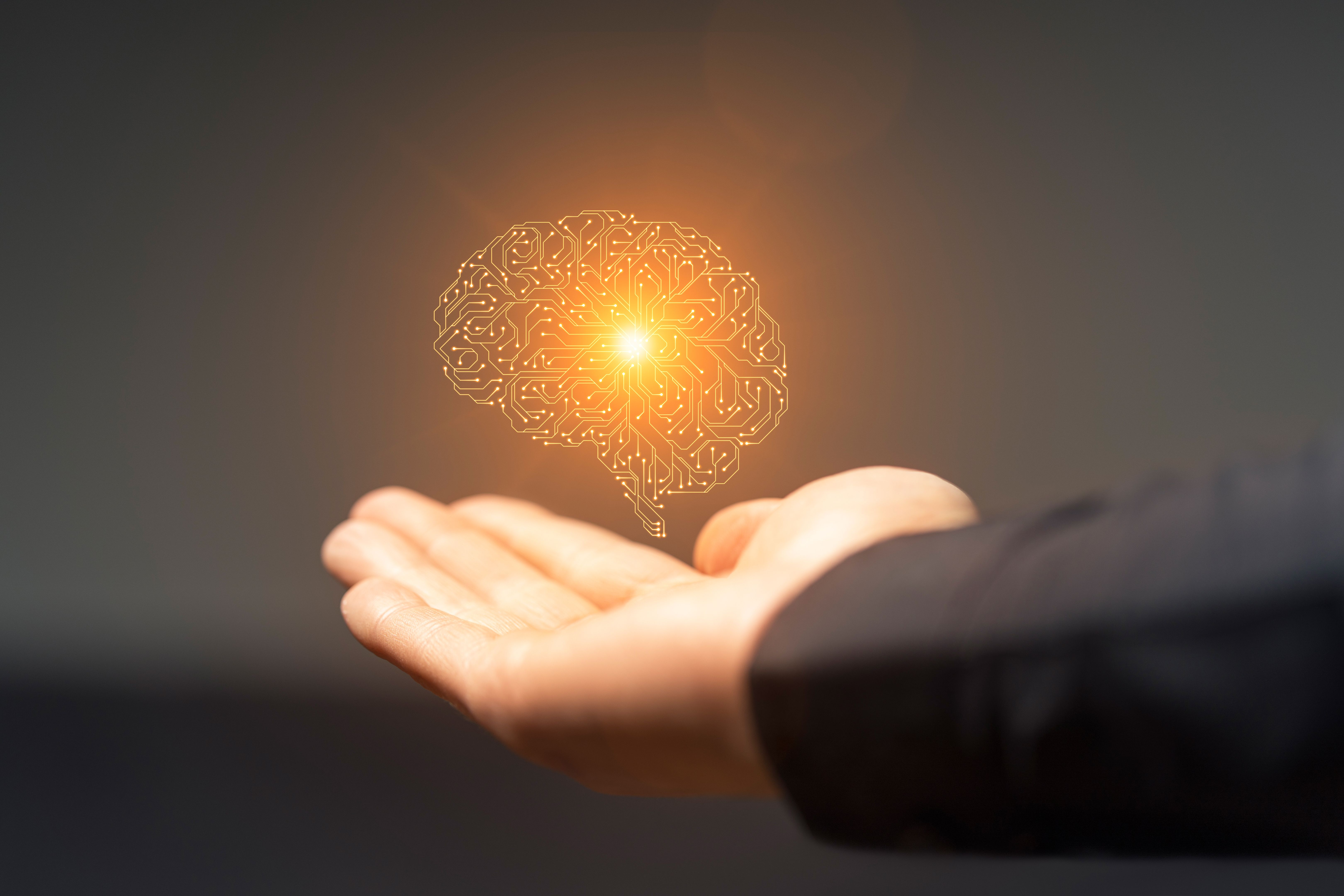 Artificial intelligence circuit board brain symbol on hand