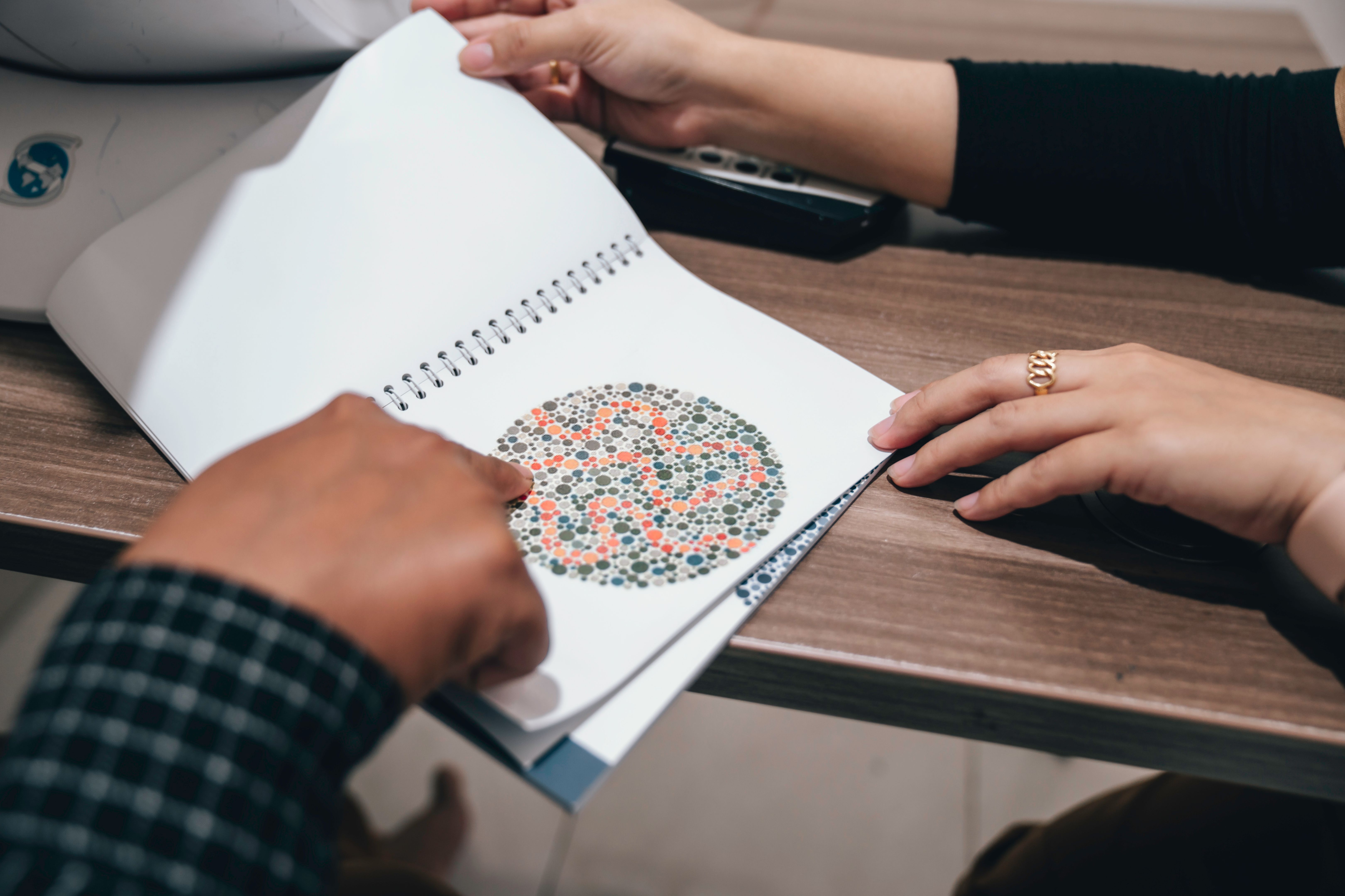 eye doctor measuring color blindness to patient