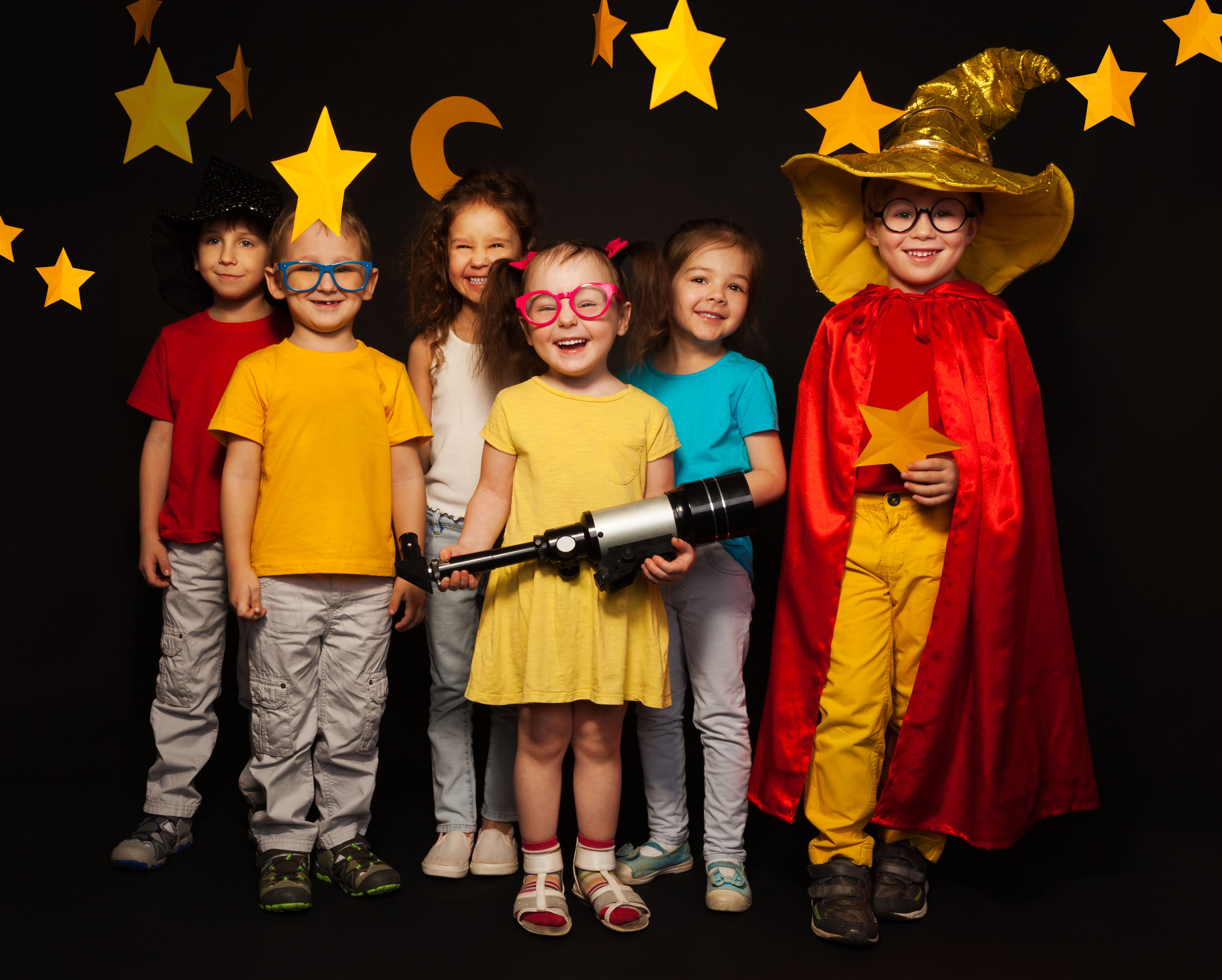 Six kids in stargazers costumes with telescope Six kids in stargazers costumes with telescope