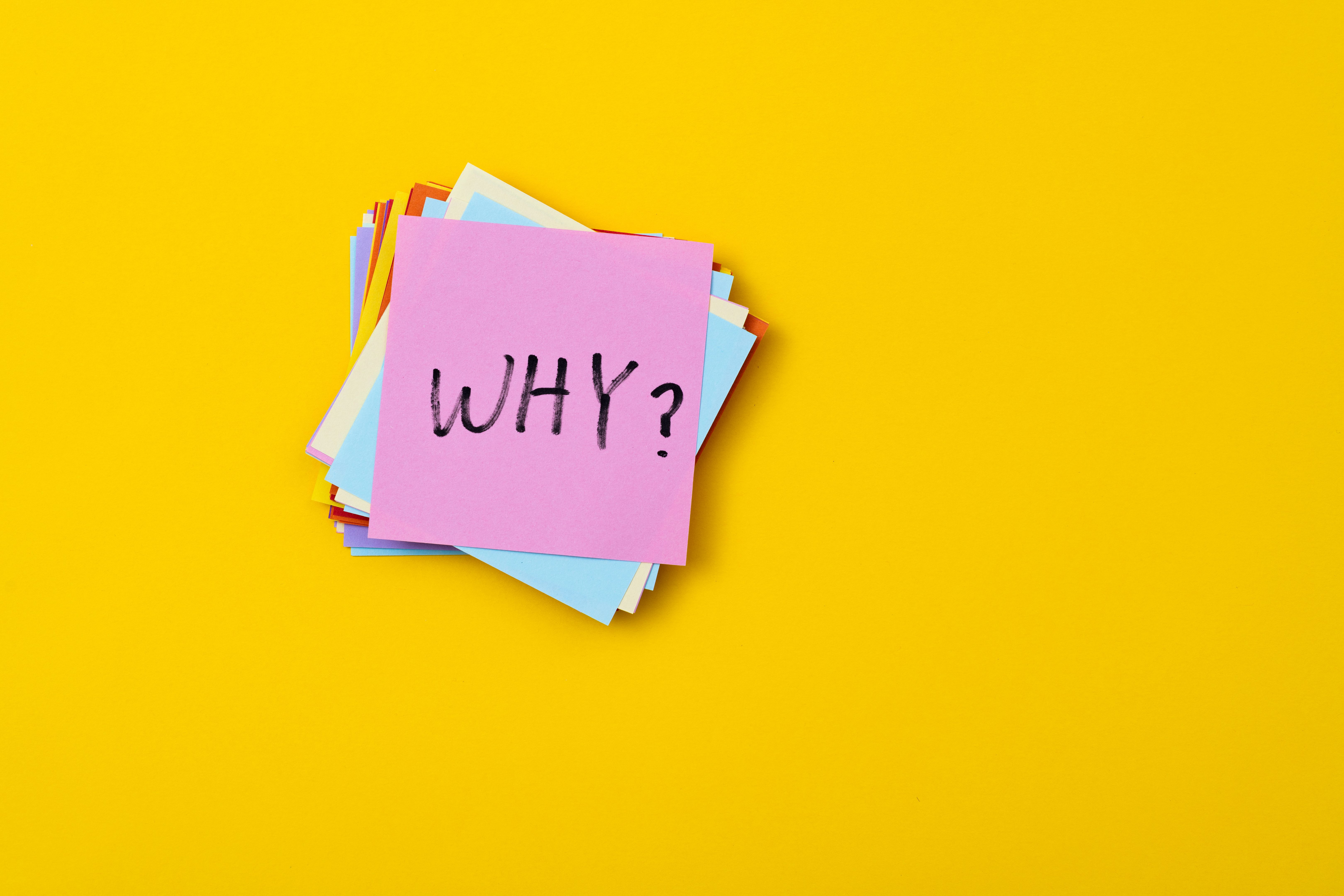 Sticky note with word why and question mark