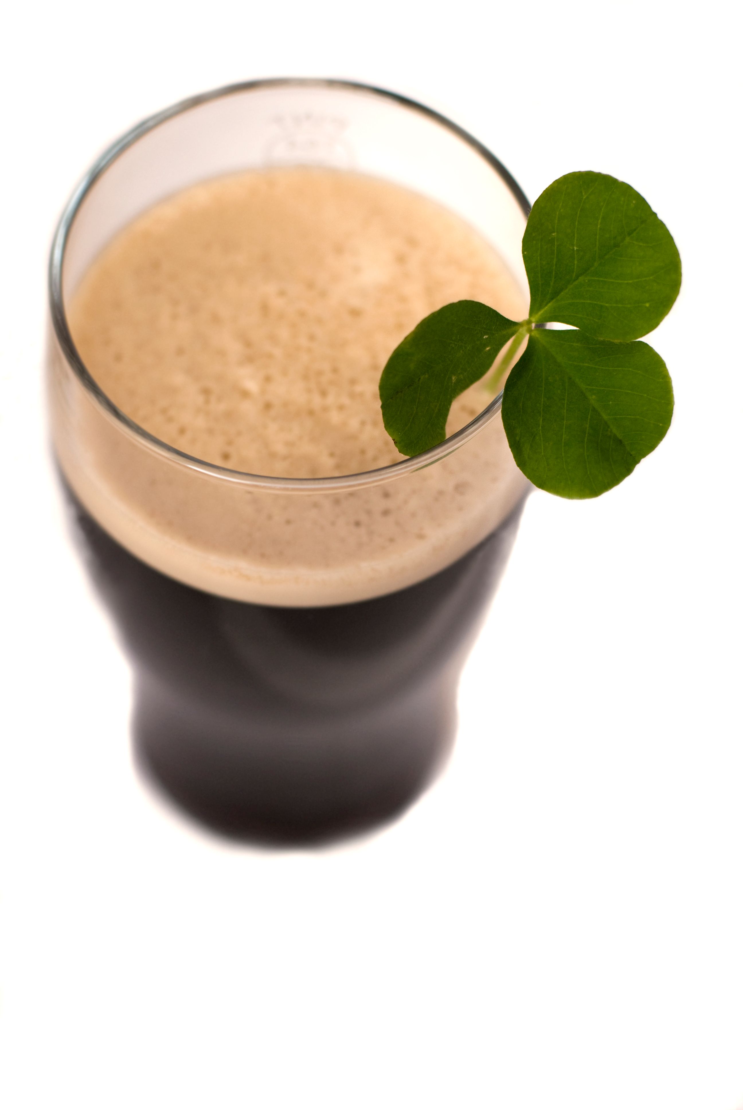 Pint of Guinness seen from above with a clover in it