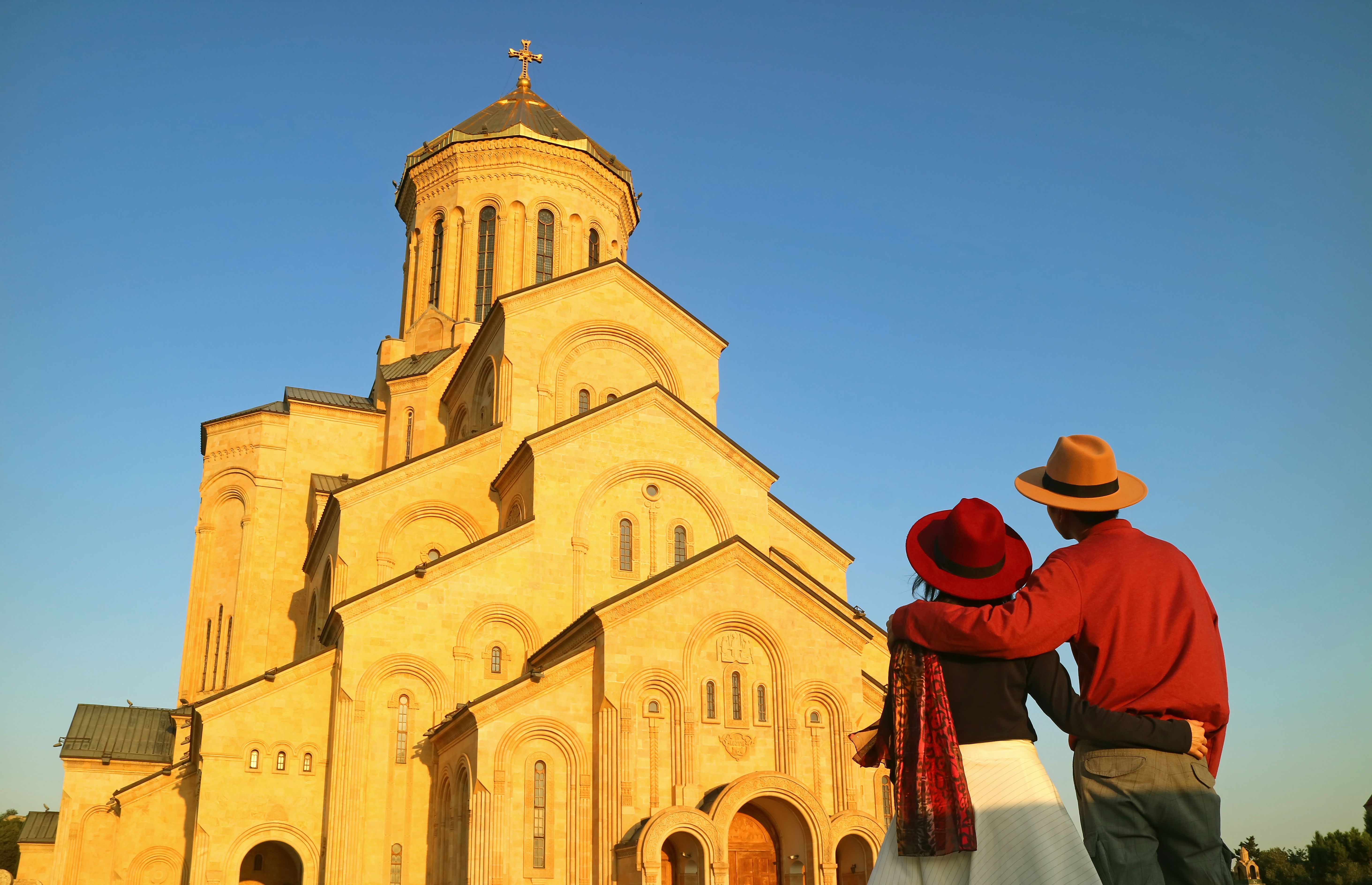 Rear View Of Couple Standing Against Church