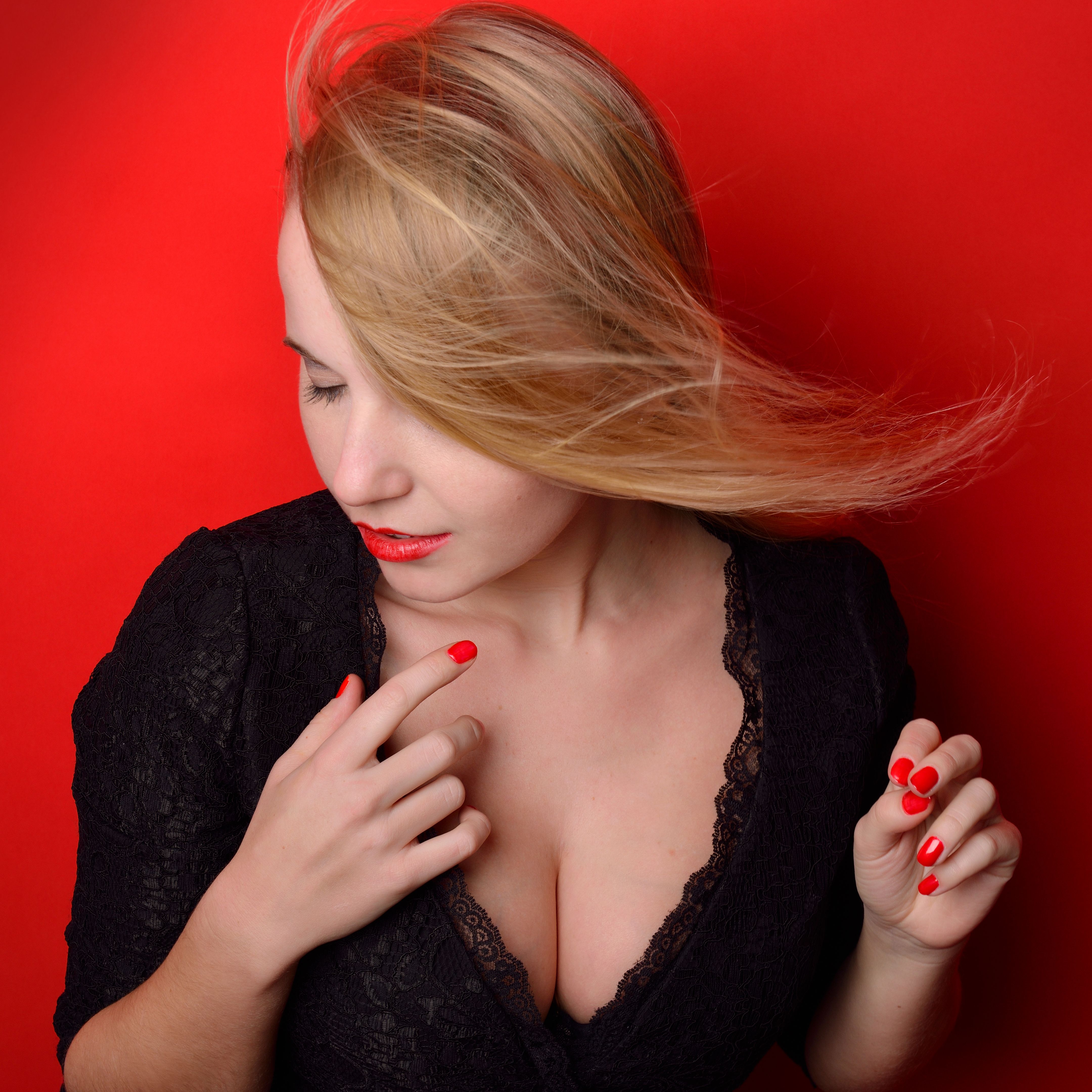 beautiful blonde  woman in black dress with ajar breast