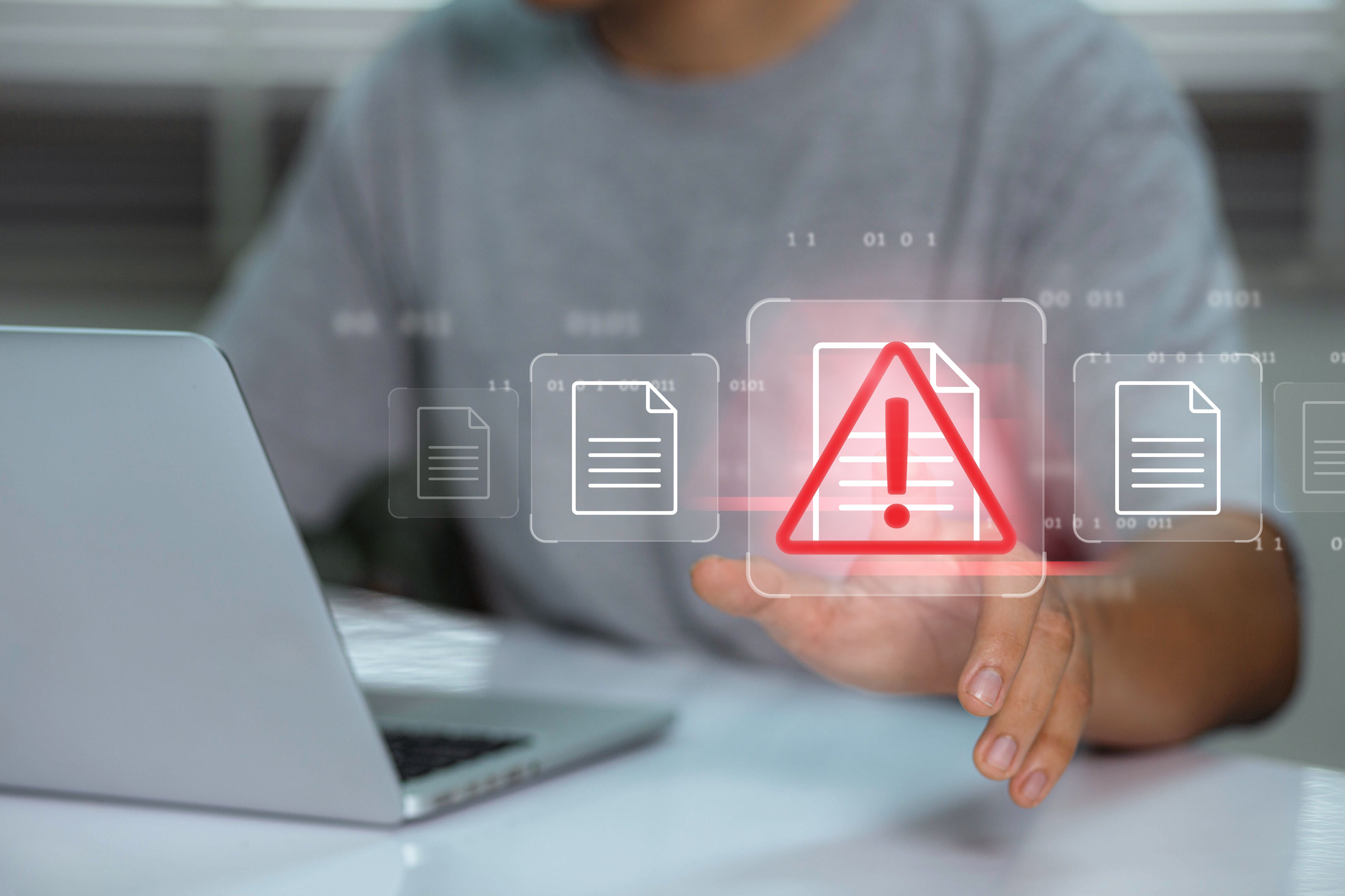 Businessman using laptop with data information privacy and document management hacking and spam warning symbol. cyber attack network, virus, spyware, Cyber security and cybercrime.