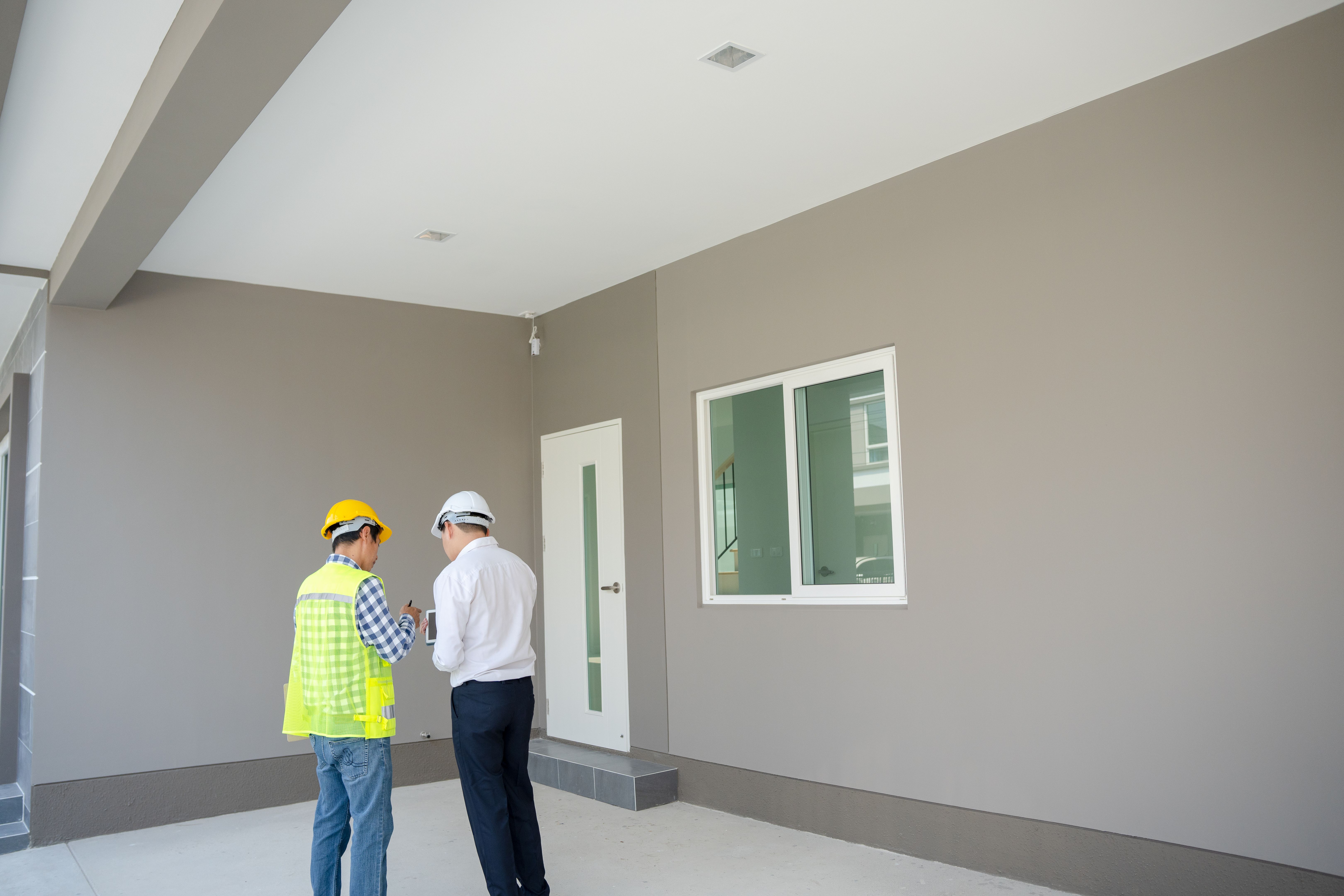inspector engineer and owner project is inspecting construction and quality assurance new house. Engineers or architects or contactor work to build the house before handing it over to the homeowner