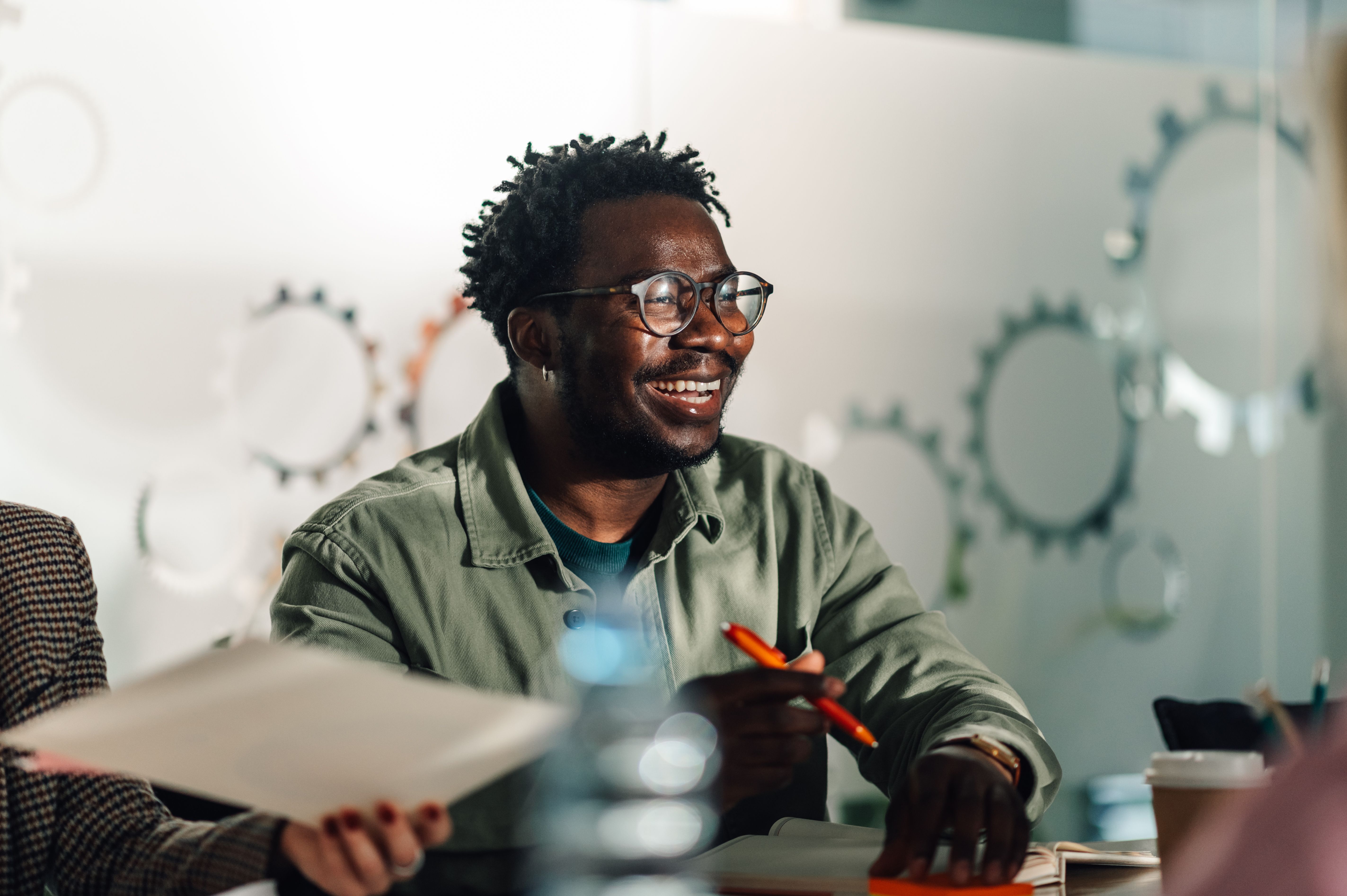 Smiling black professional attending a business meeting in modern office