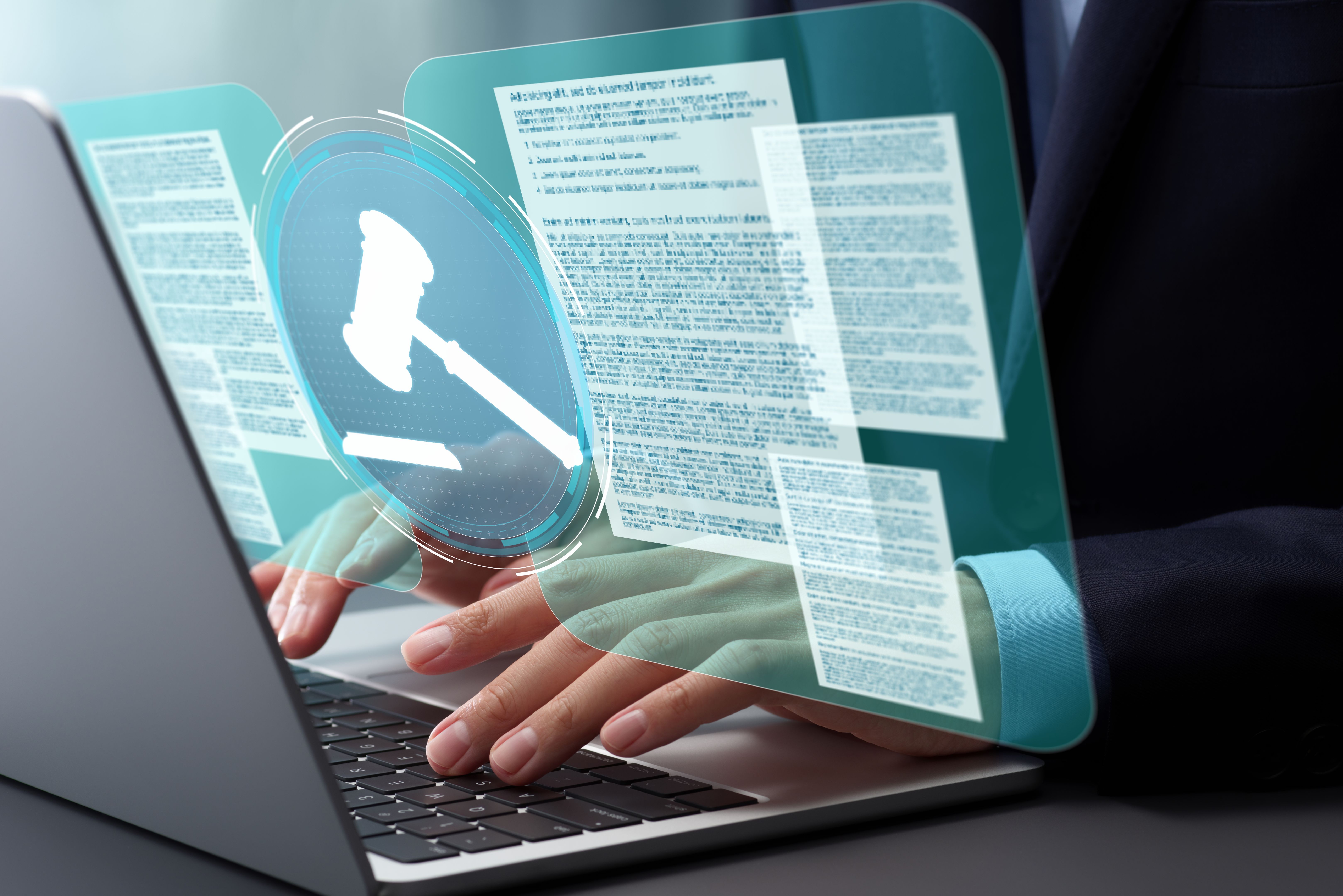 Legal documents and gavel hammer icon. Lawyer reviewing and preparing legal documents for court cases. Hands typing on laptop computer keyboard at desk in office.