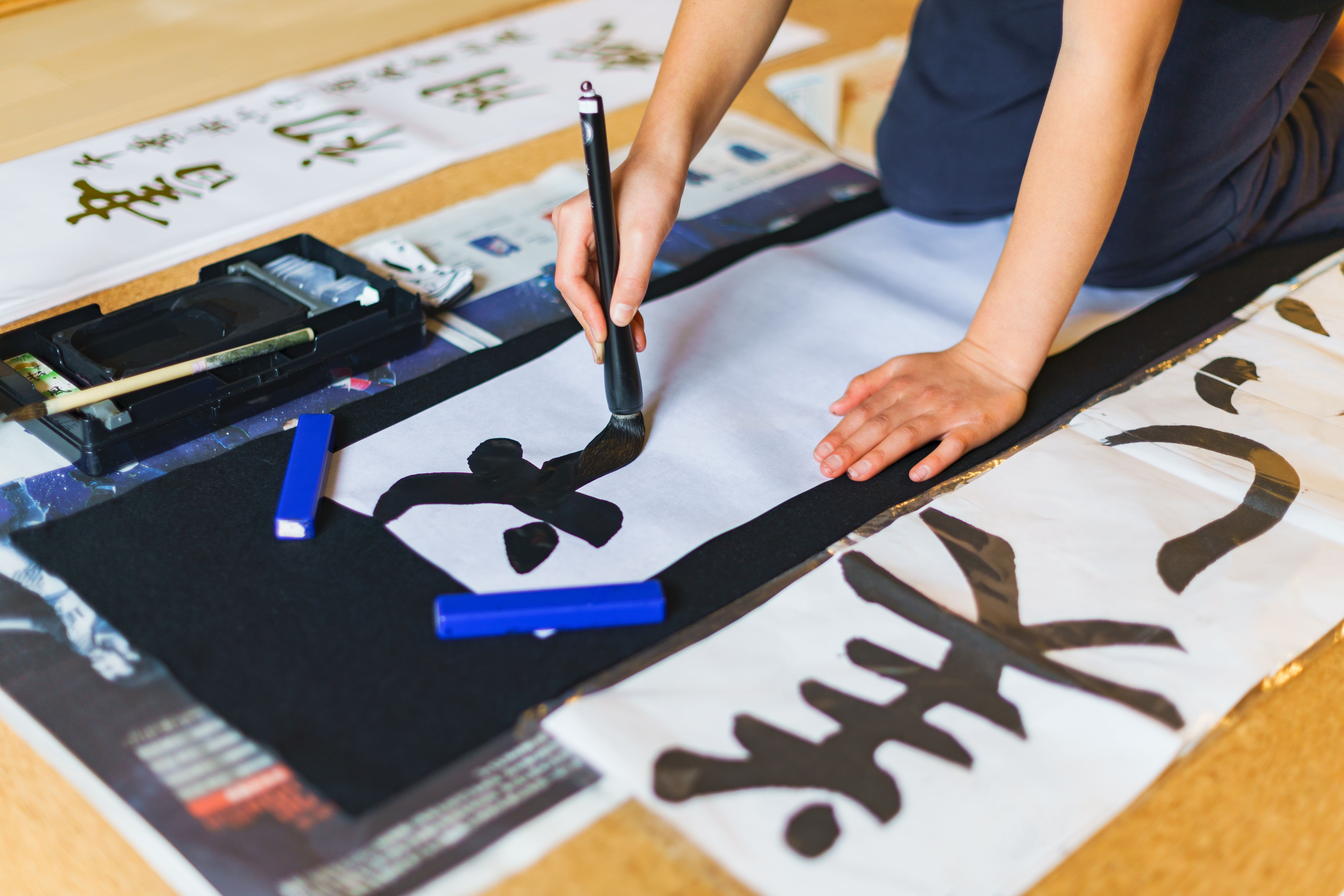 Japanese woman writing Chinese character