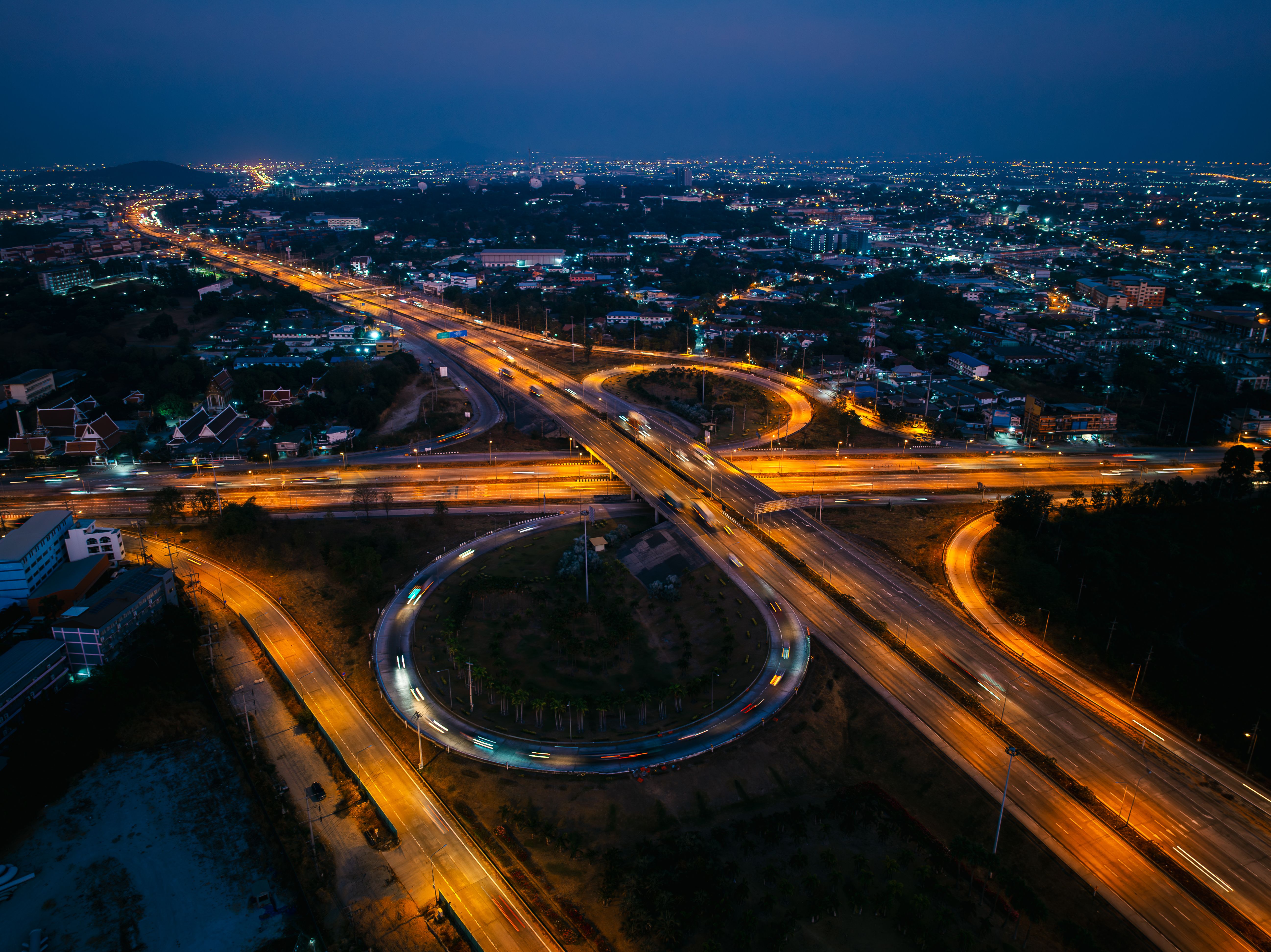 aerial view at twiligh scene, ring road and oil and gas refinery factory plant, business and industrial about financial and transportation, waste energy and air pollution, pink sky background.