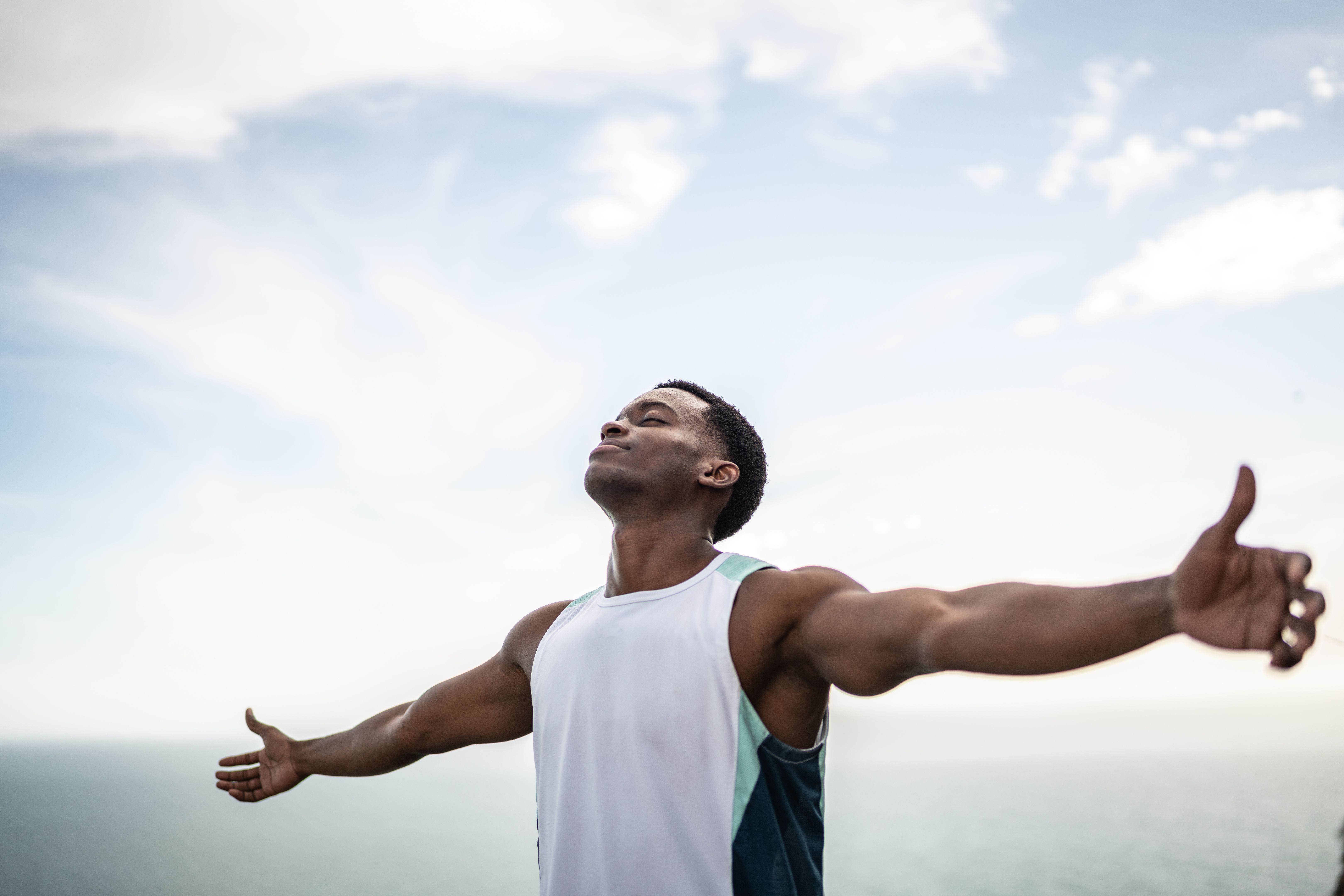 Young man with arms outstretched outdoors Young man with arms outstretched outdoors