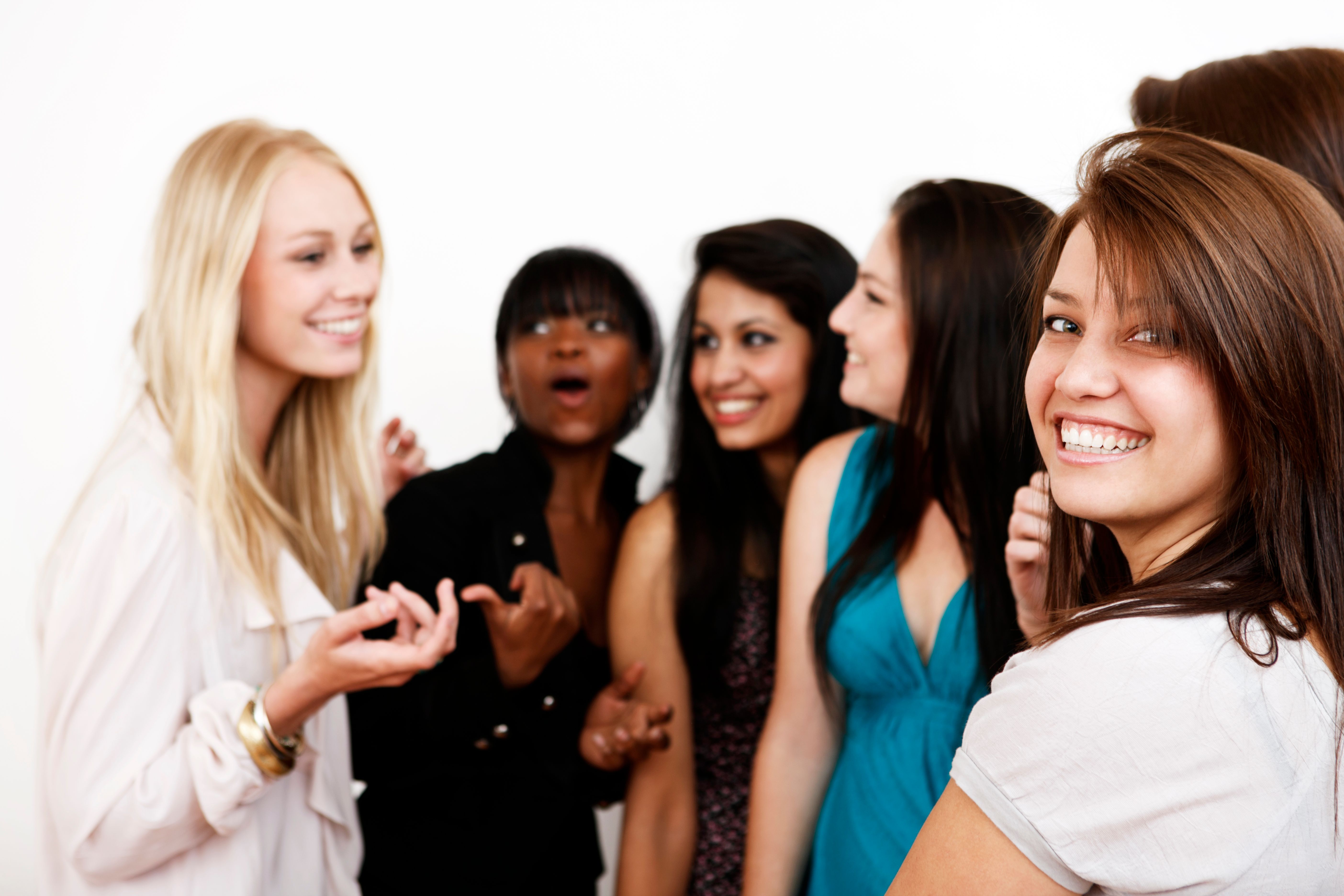 Group of young women smile and chat