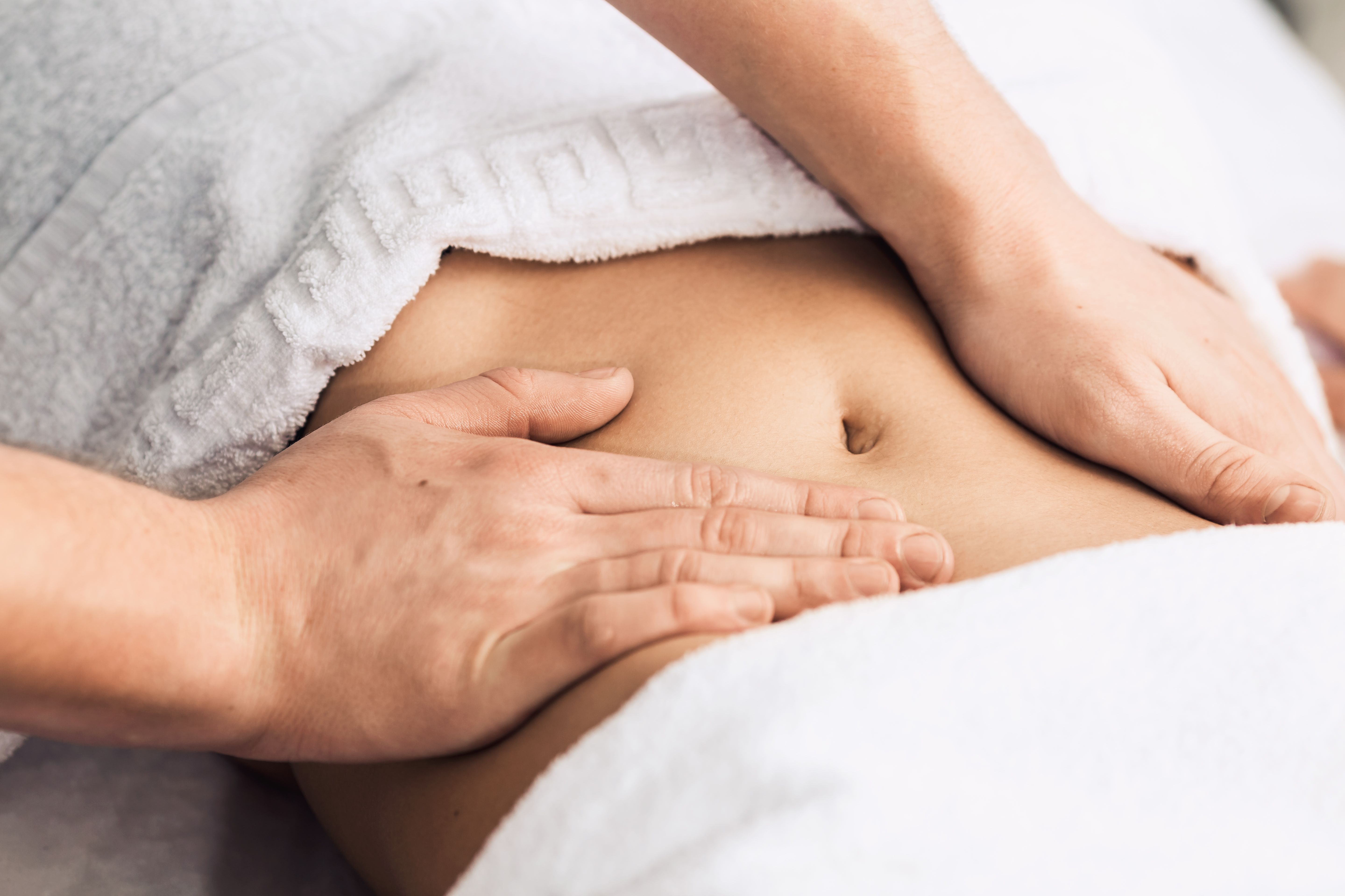 Massage of the stomach in the spa. Cosmetic clinic, spa, wellness center, healthcare concept.