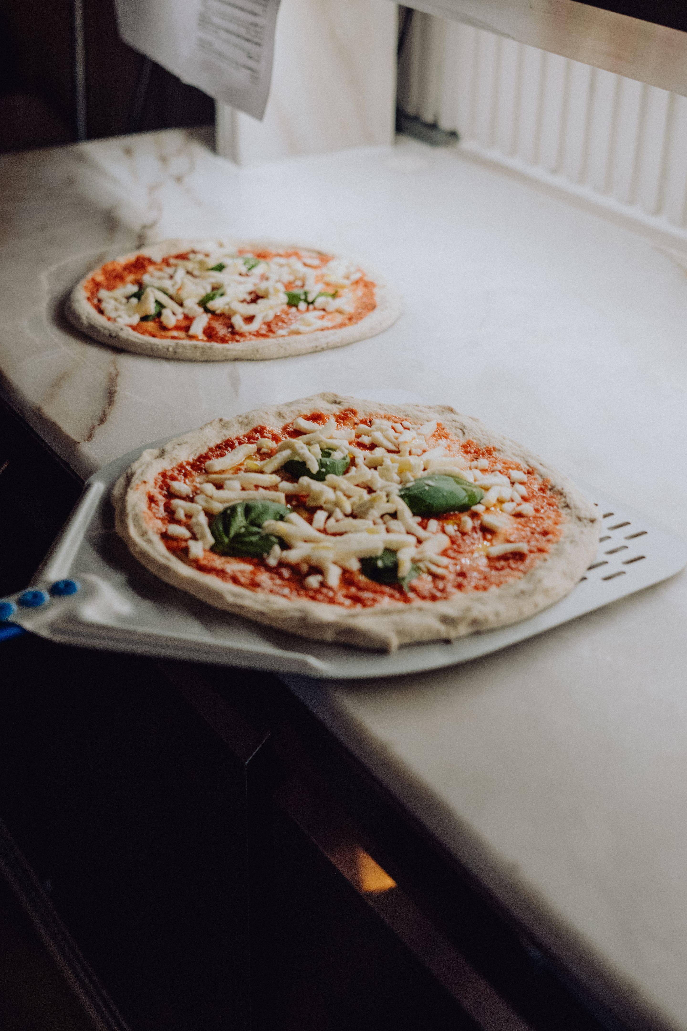 adding pizza toppings