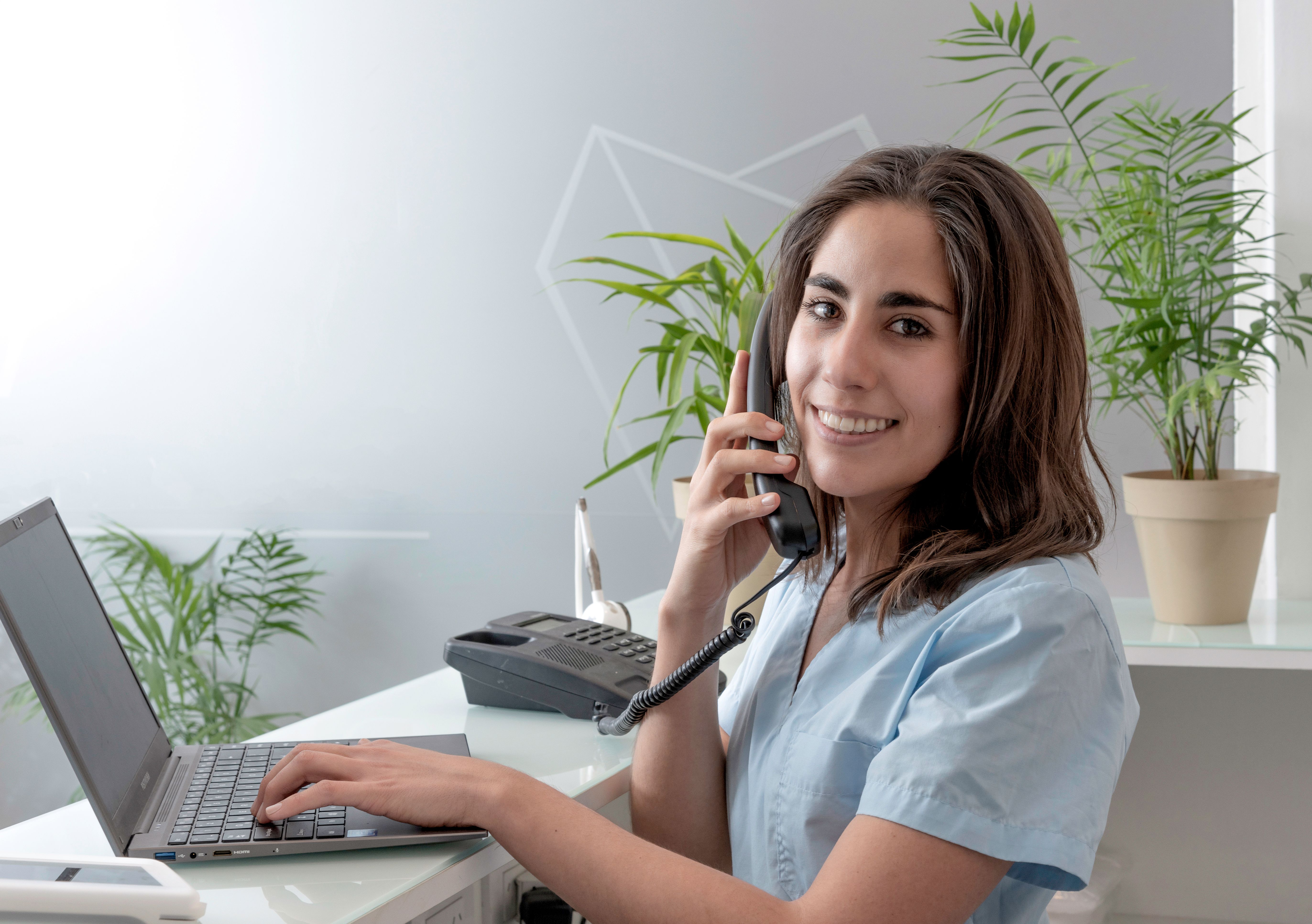 young woman working at the reception of a dental office