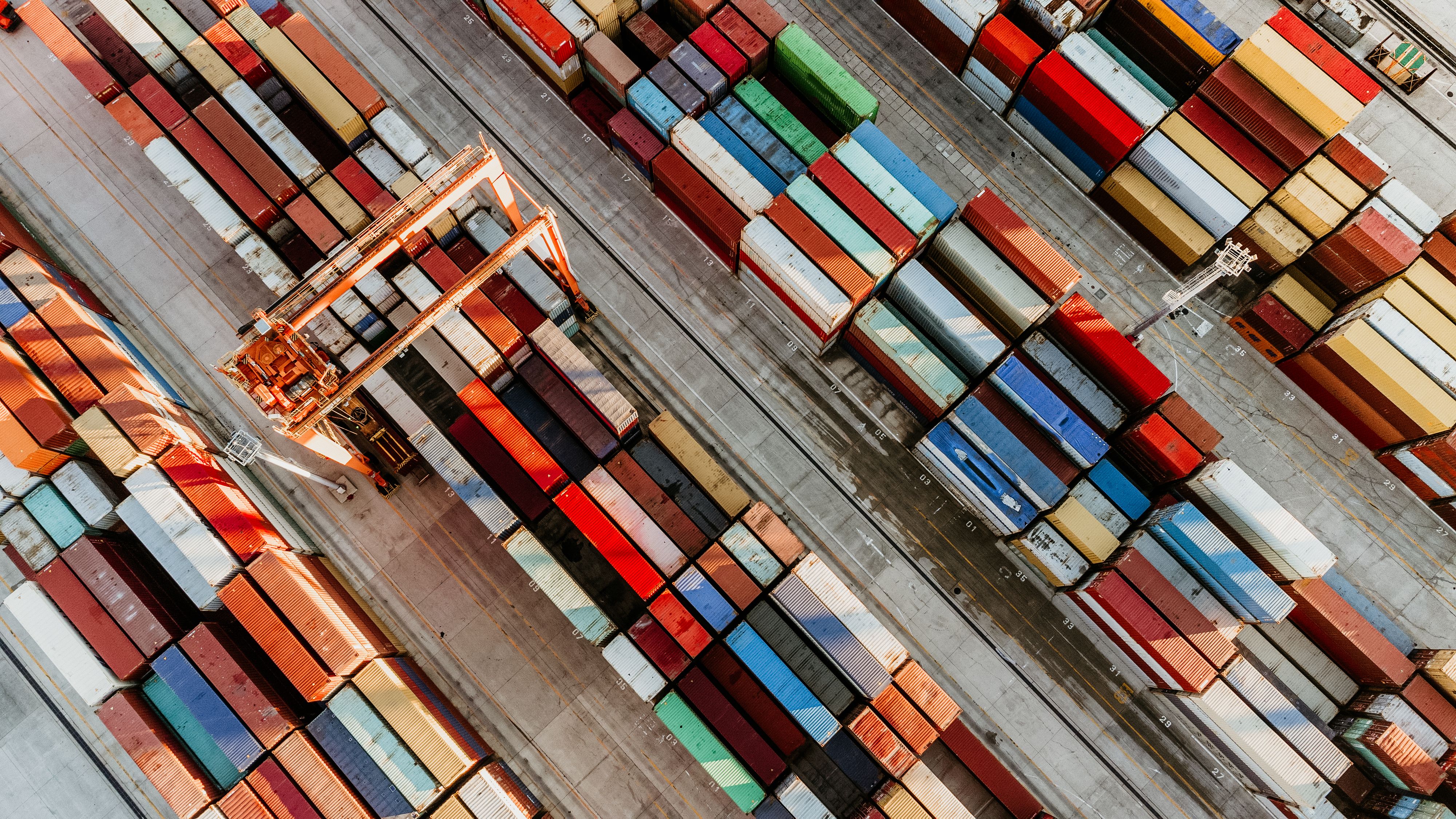 Aerial view of shipping container port terminal. Colourful pattern of containers in harbor. Maritime logistics global inport export trade transportation.