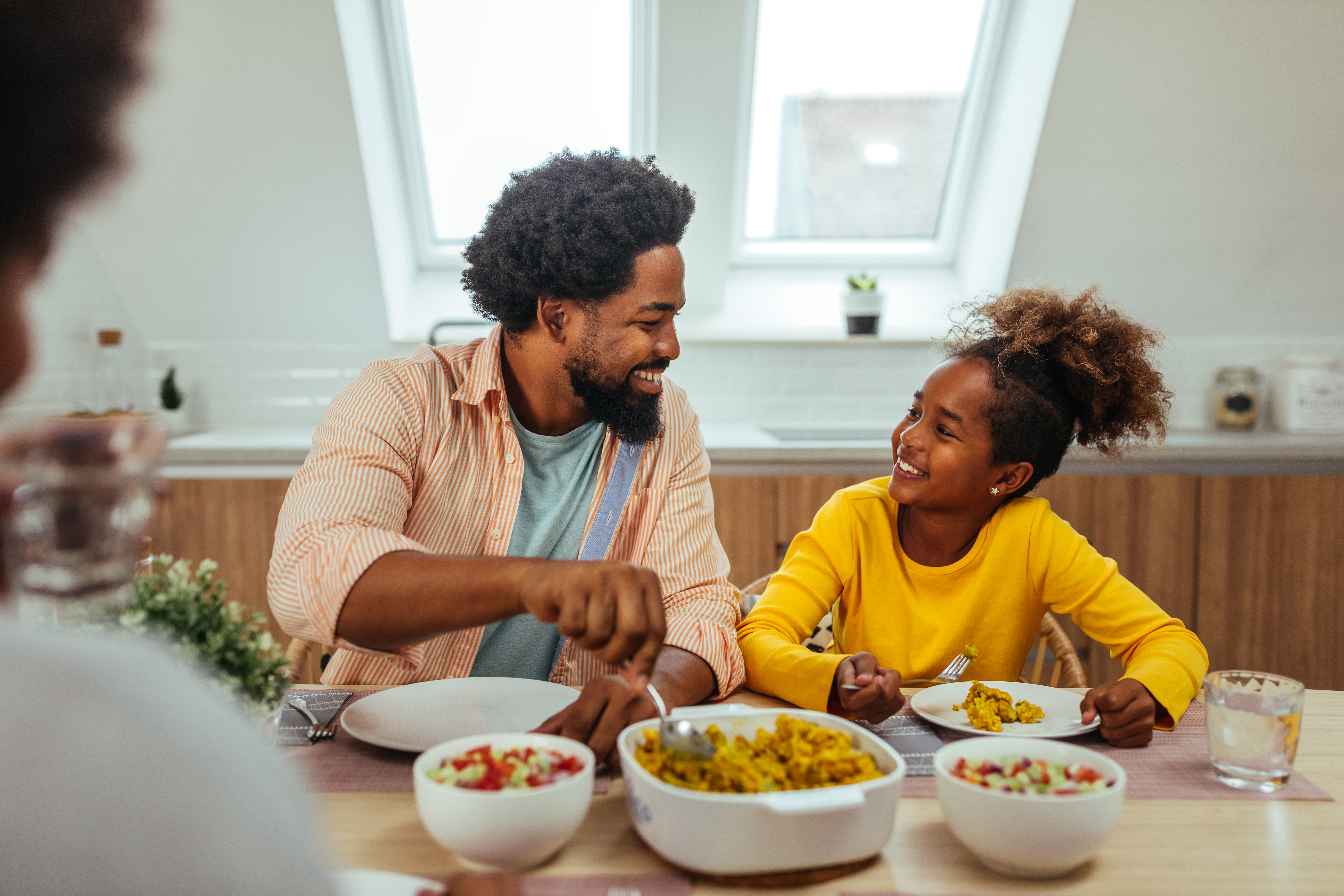 Cute afro family having lunch together at home