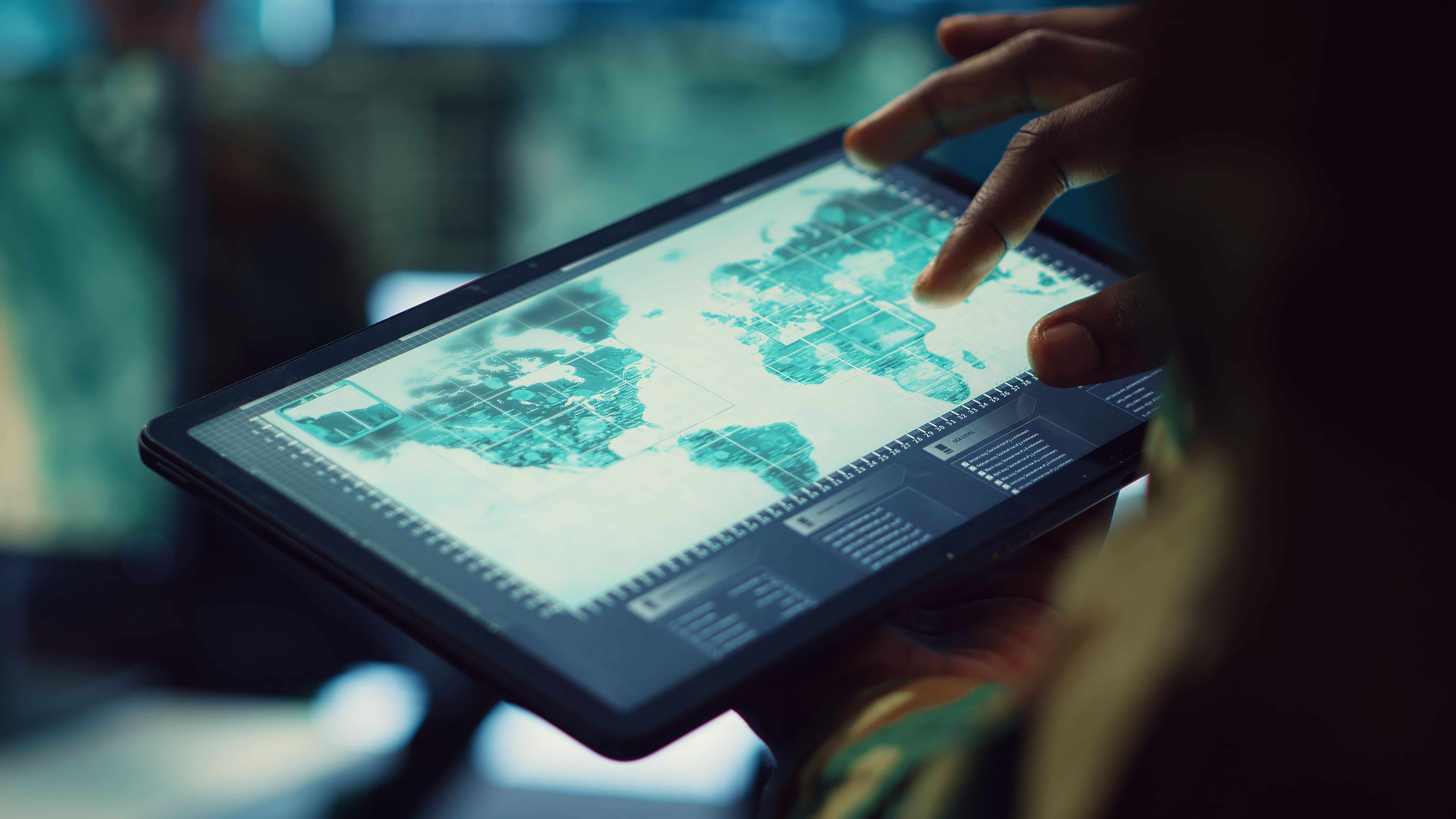 Navy operations specialist examines a world map with gps system on his tablet
