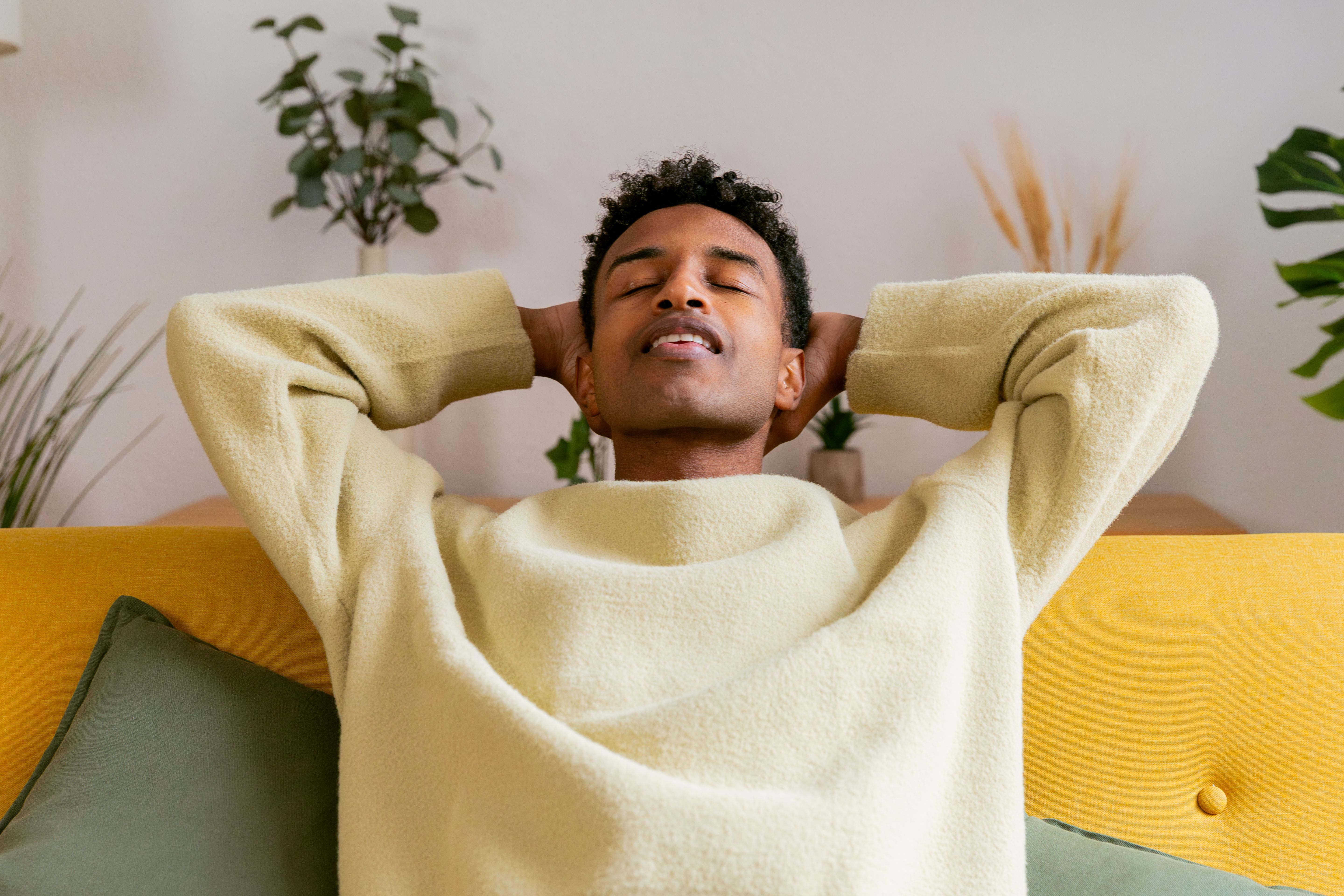 Young man relaxing with eyes closed on sofa