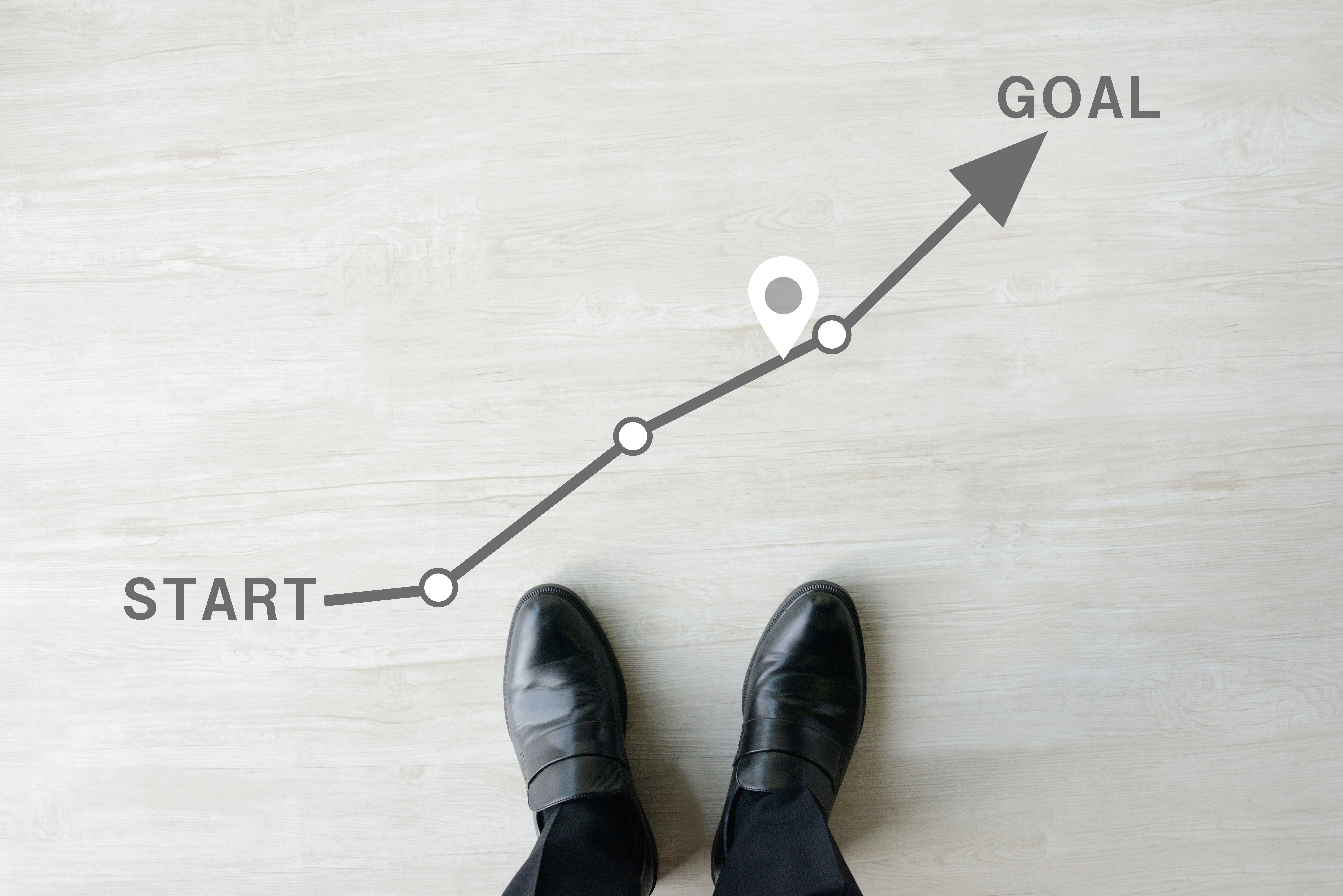 Business man's feet and route with start and goal word