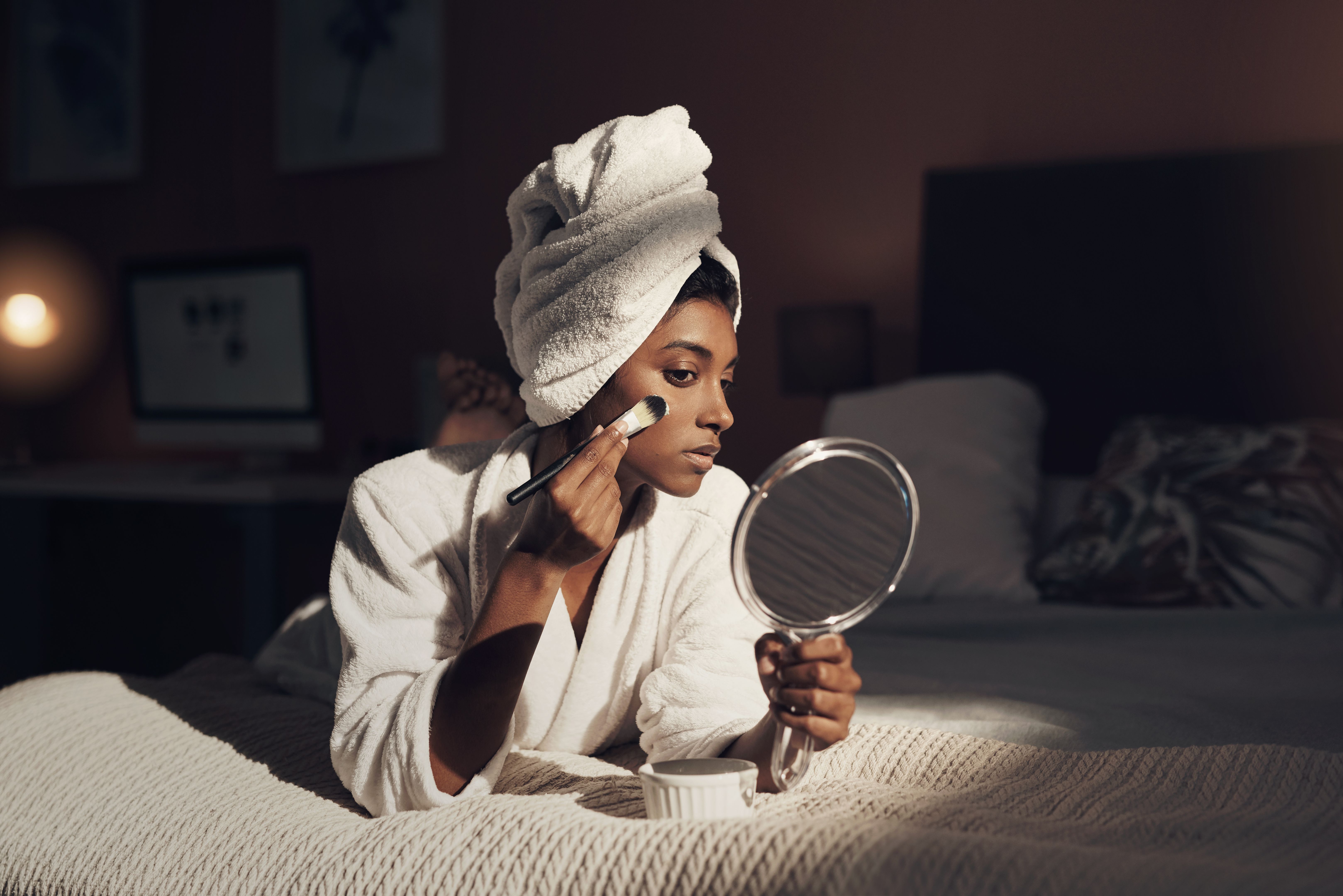 woman applying foundation