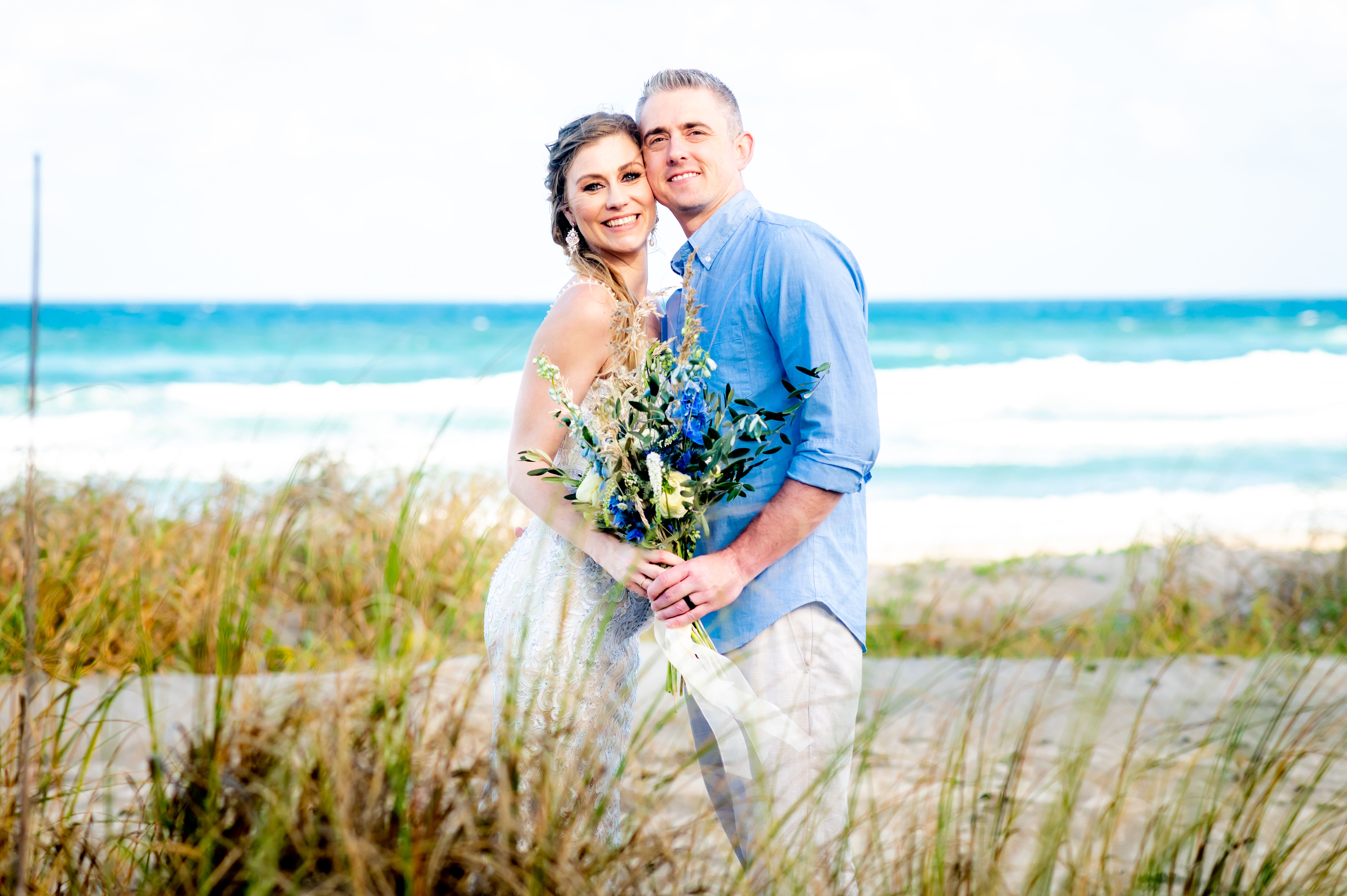Beautiful bride and groom at their destination wedding outdoors in an affectionate portrait Beautiful bride and groom at their destination wedding outdoors in an affectionate portrait