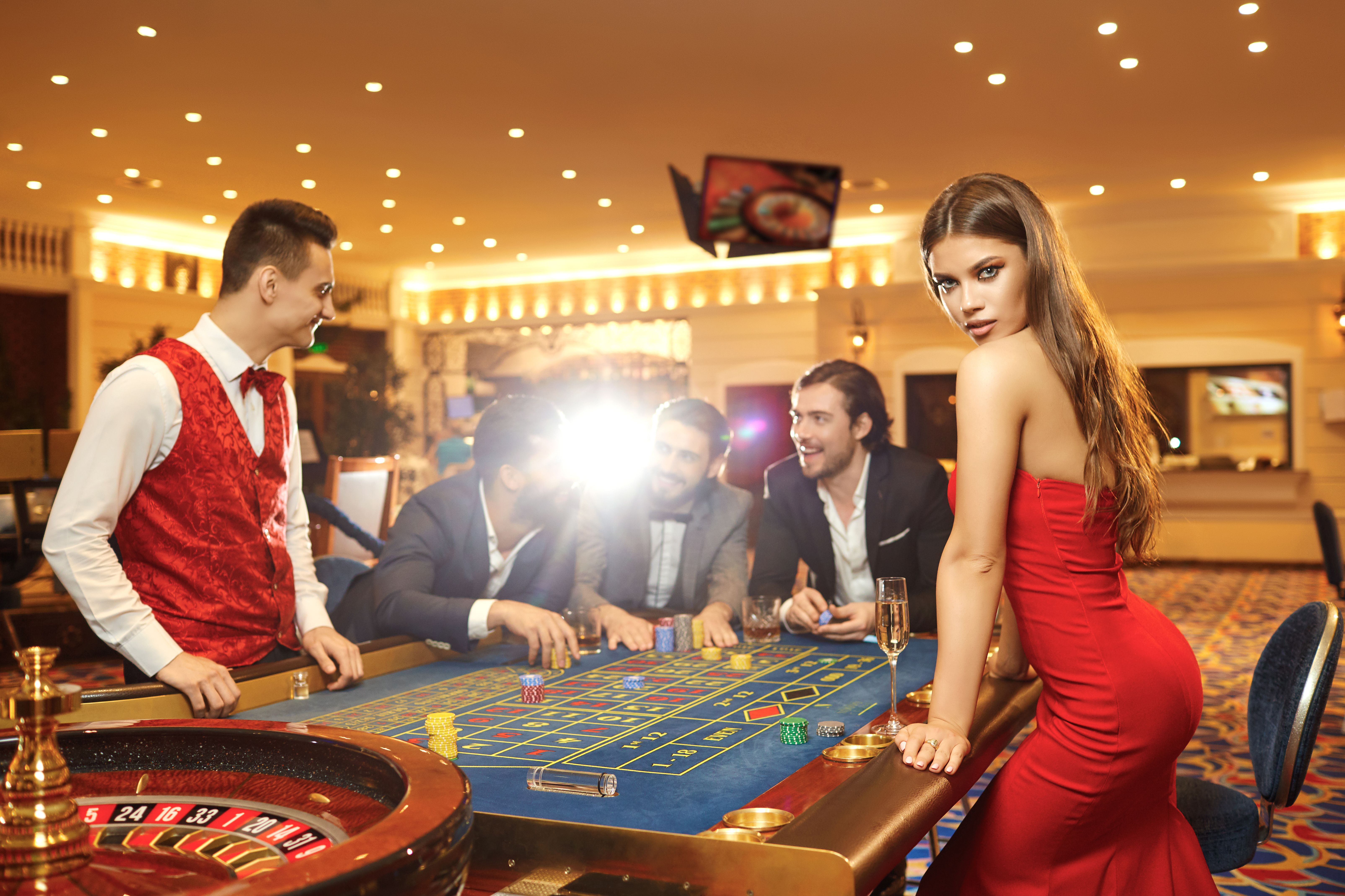 A woman with in a dress at table roulette in casino. A woman with in a dress at table roulette in casino.