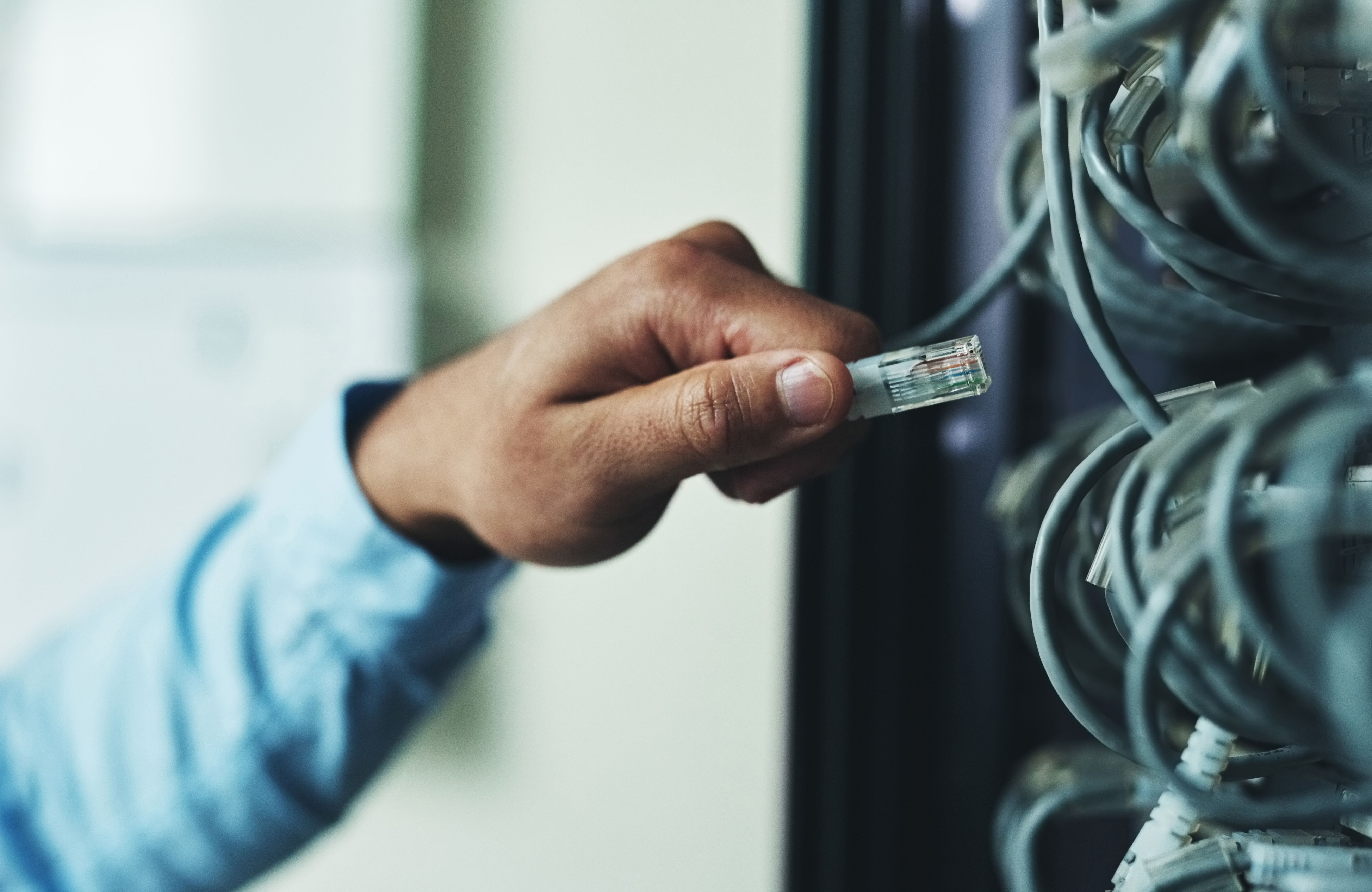 Cropped shot of an unrecognizable technician standing alone and adjusting the mainframe
