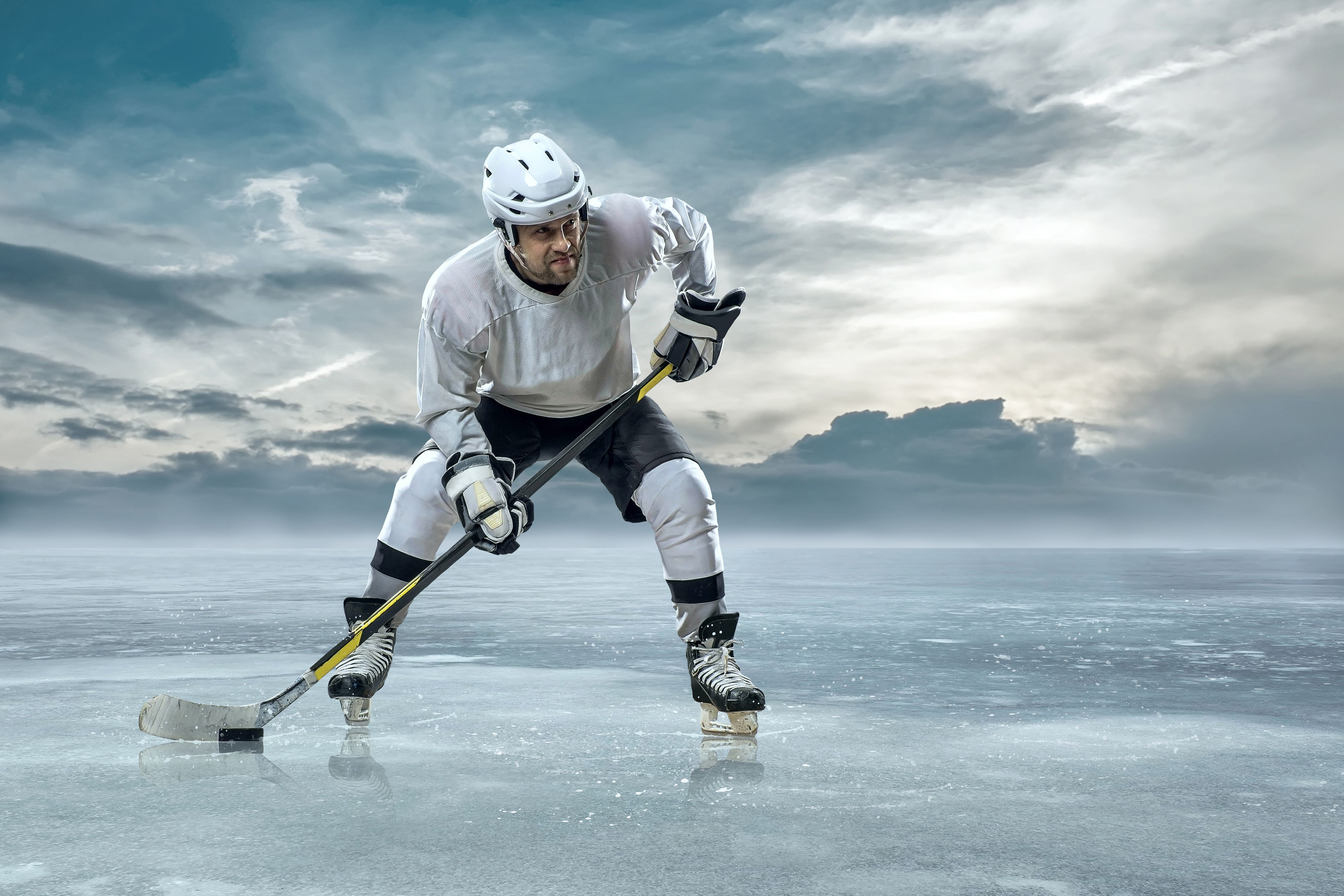 Ice hockey player on the ice in mountains