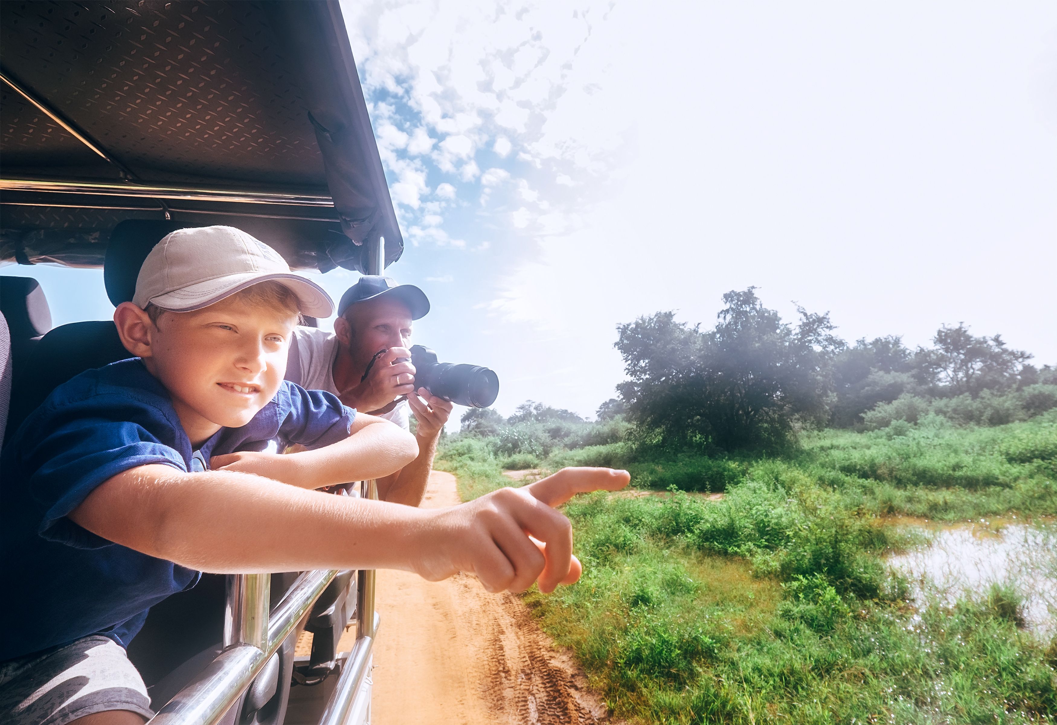 Son and father saw the animals on safari in nature park