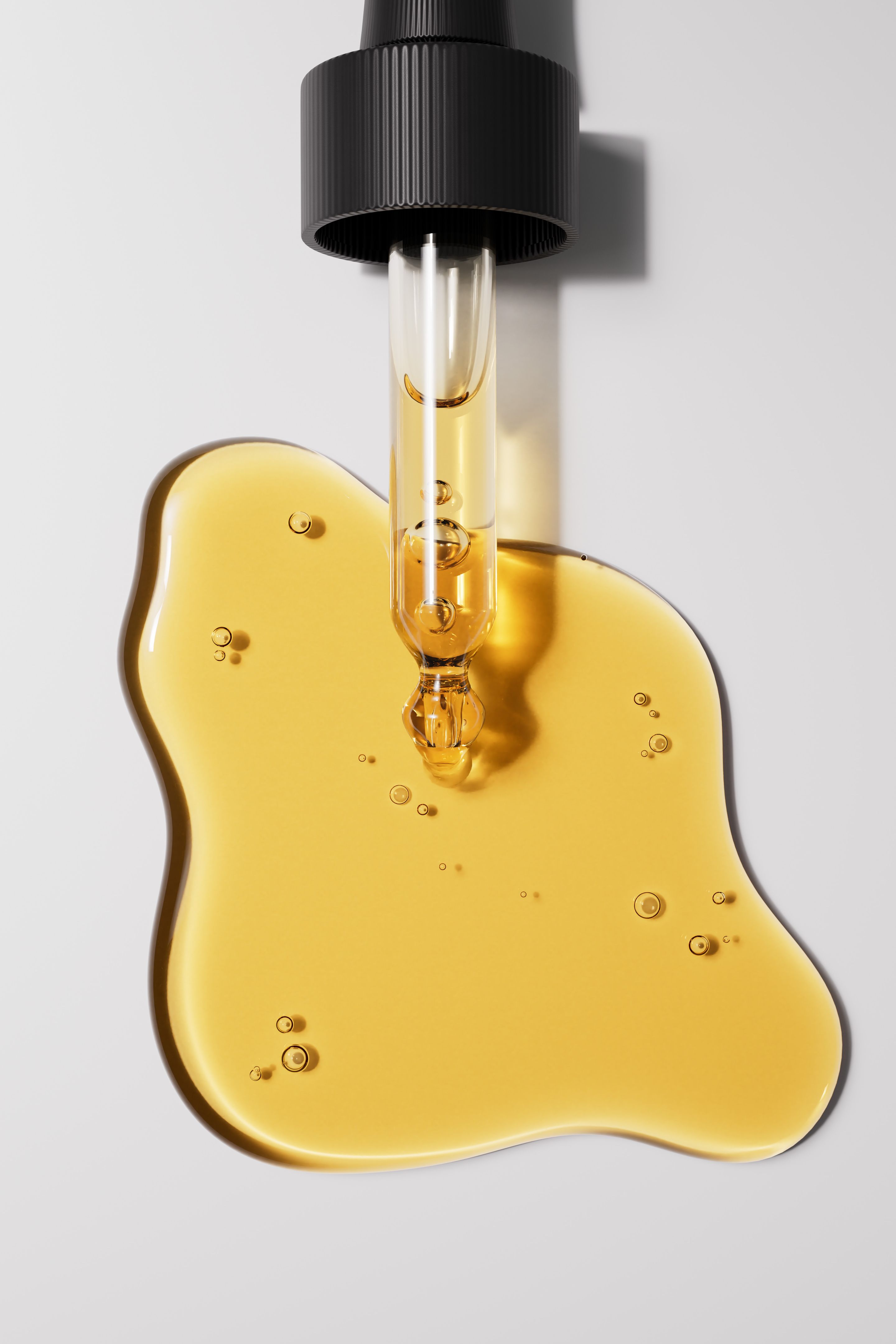 A close-up of a golden oil dropper with a pool of smooth, clear oil on a white background. Natural face serum skin care beauty product 3d rendering