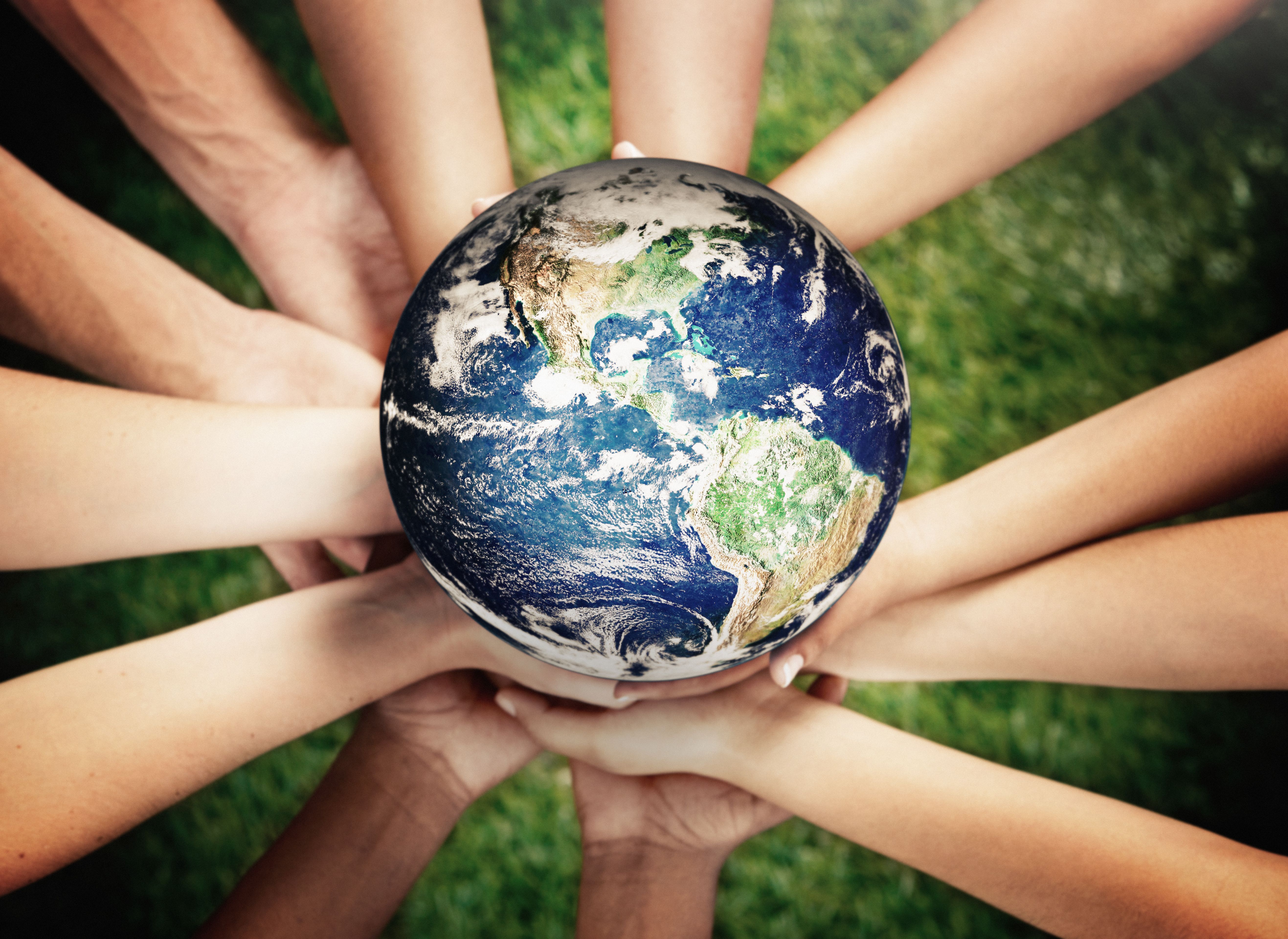 Group of caring young men and women supporting Planet Earth Group of caring young men and women supporting Planet Earth