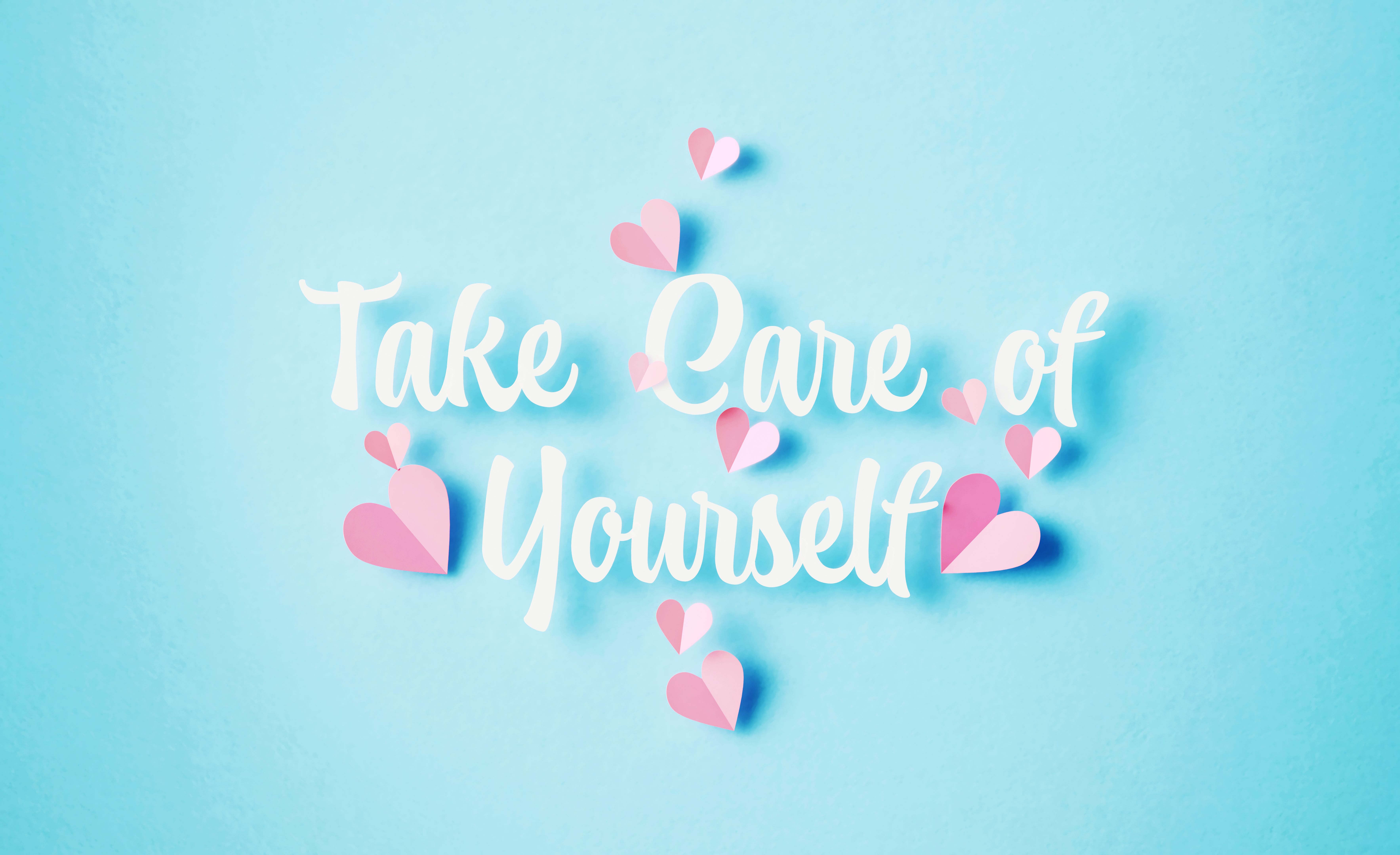 Take Care Of Yourself Message Surrounded By Pink Heart Shapes On Blue Background