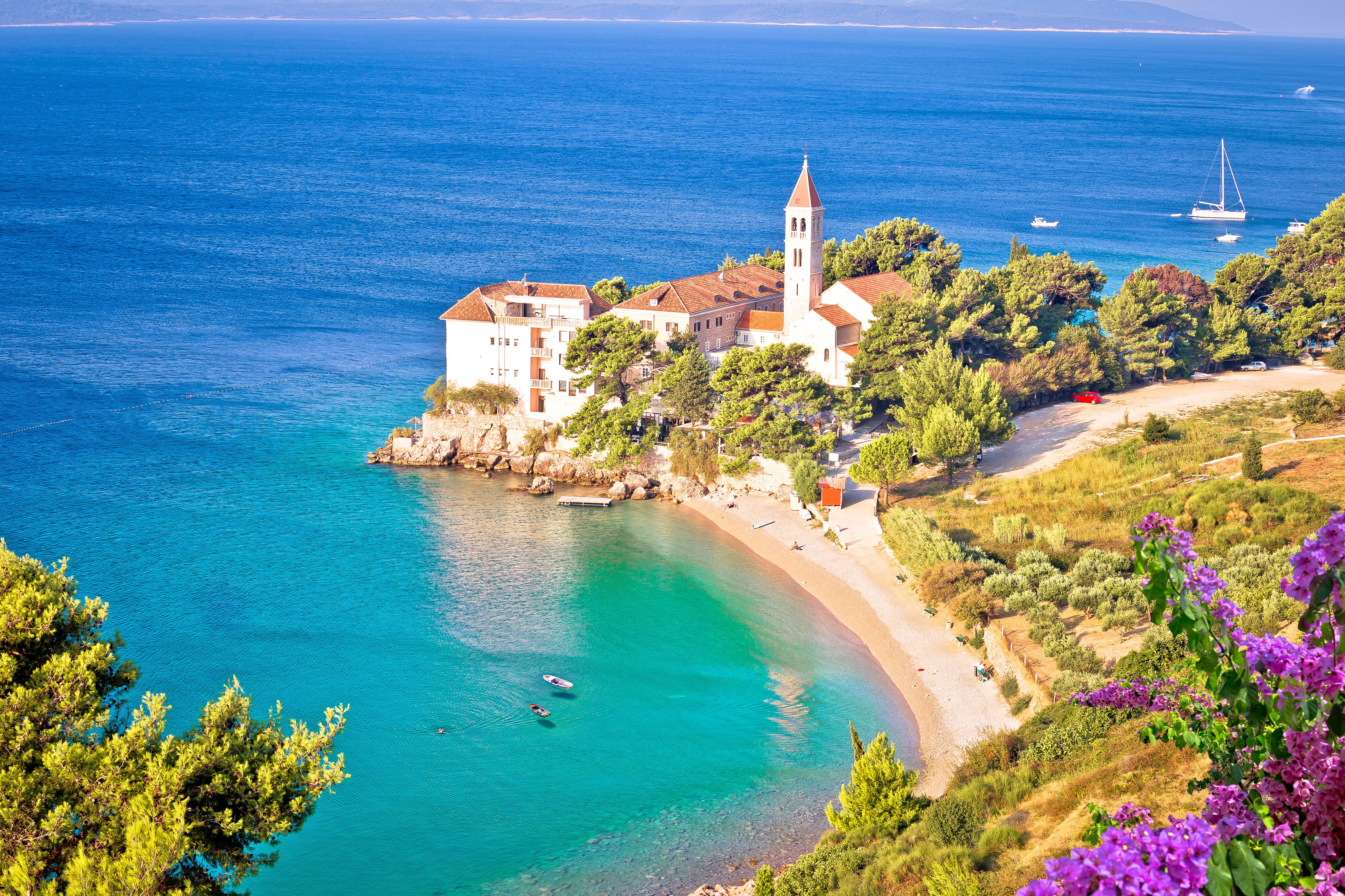 Bol on Brac island. Monastery on pebble beach in Bol view